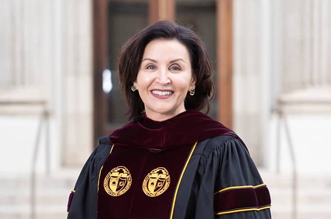 a person wearing a black and red robe