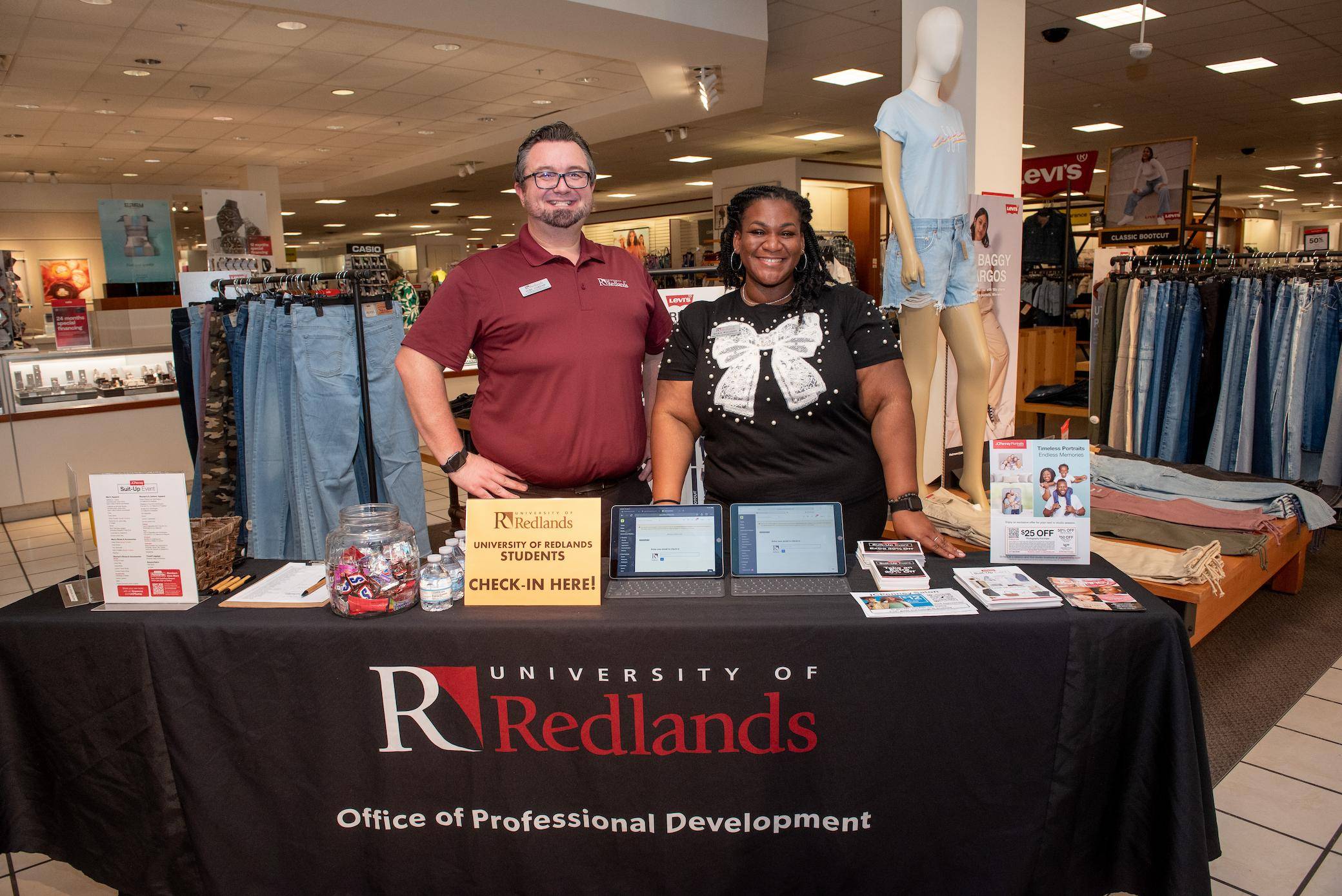 a person and person standing behind a table