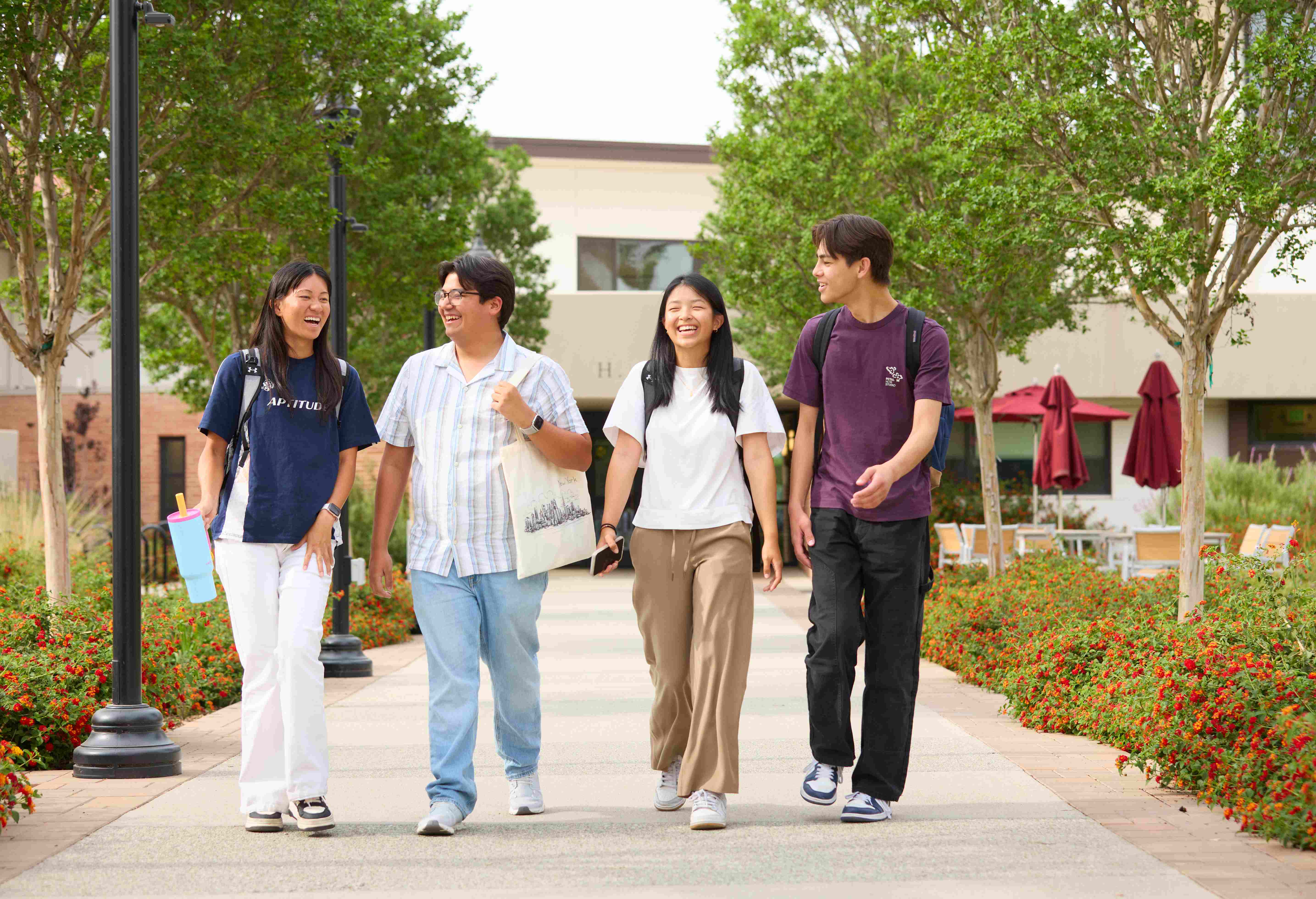 a group of people walking on a sidewalk