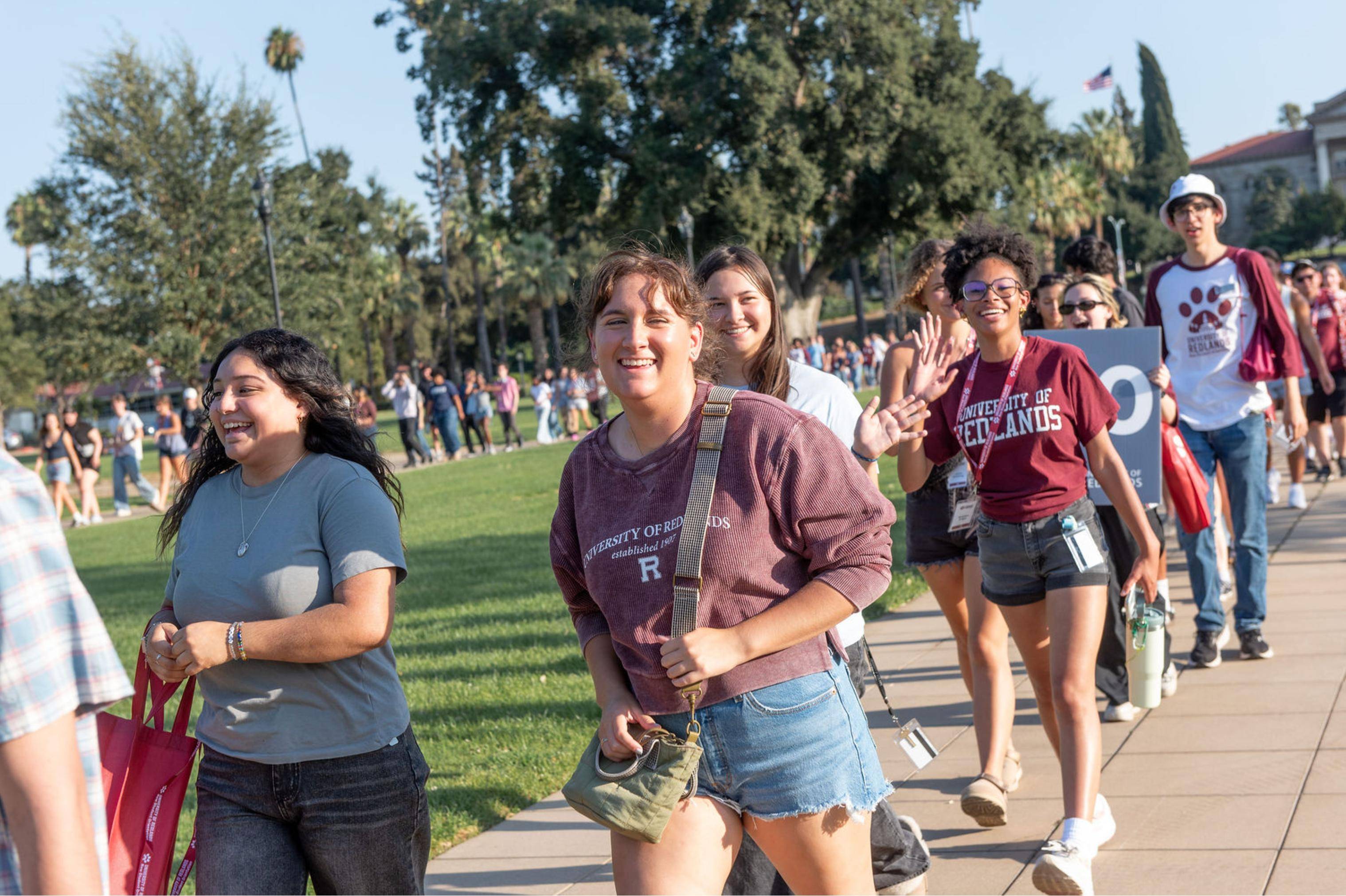 a group of people walking on a sidewalk