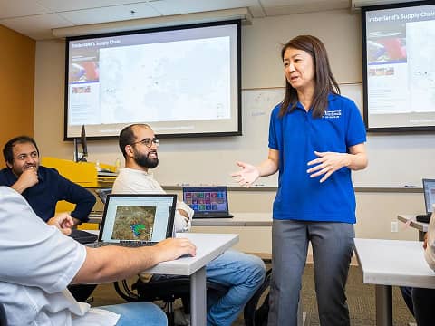 a person standing in front of a group of people