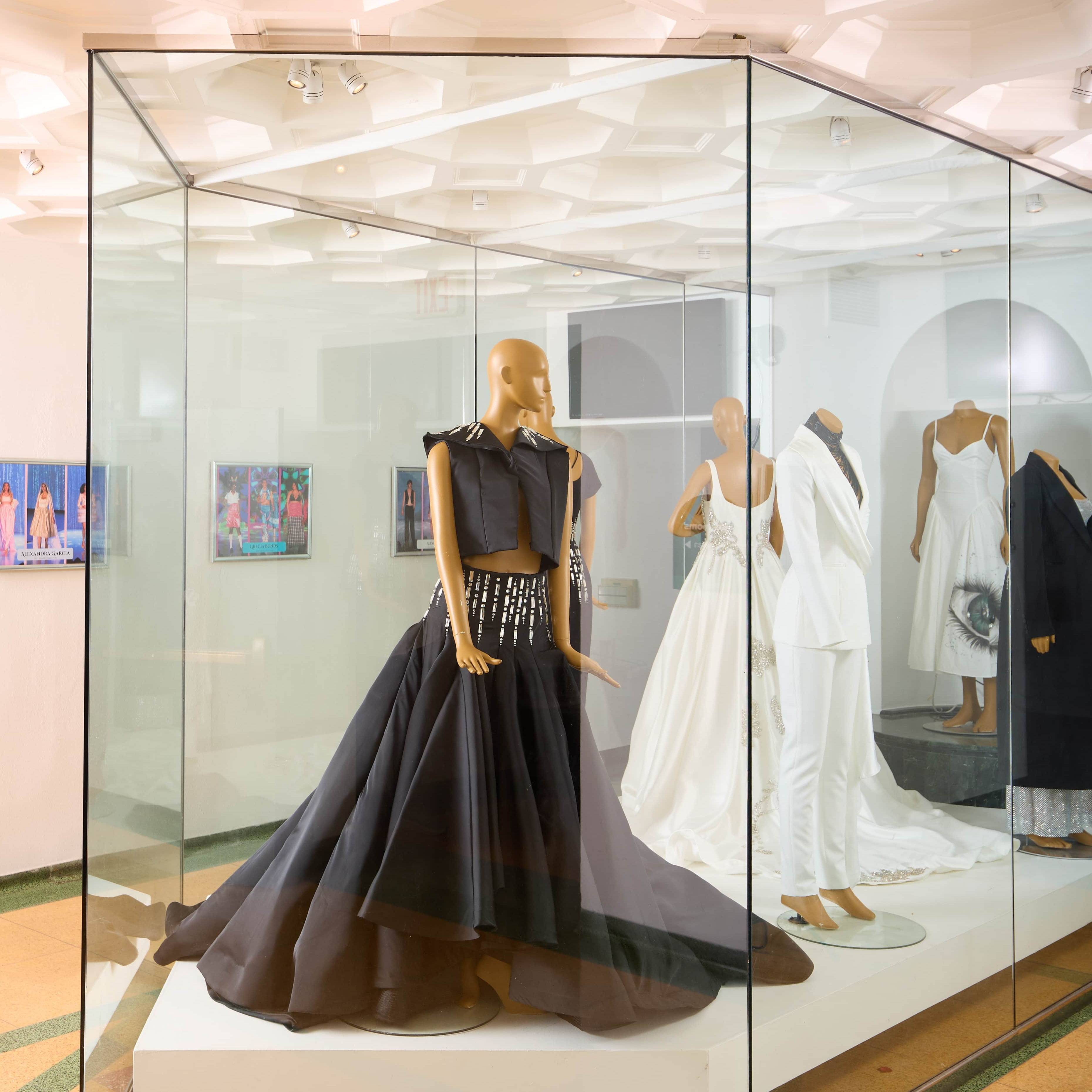 a personnequins in a glass case