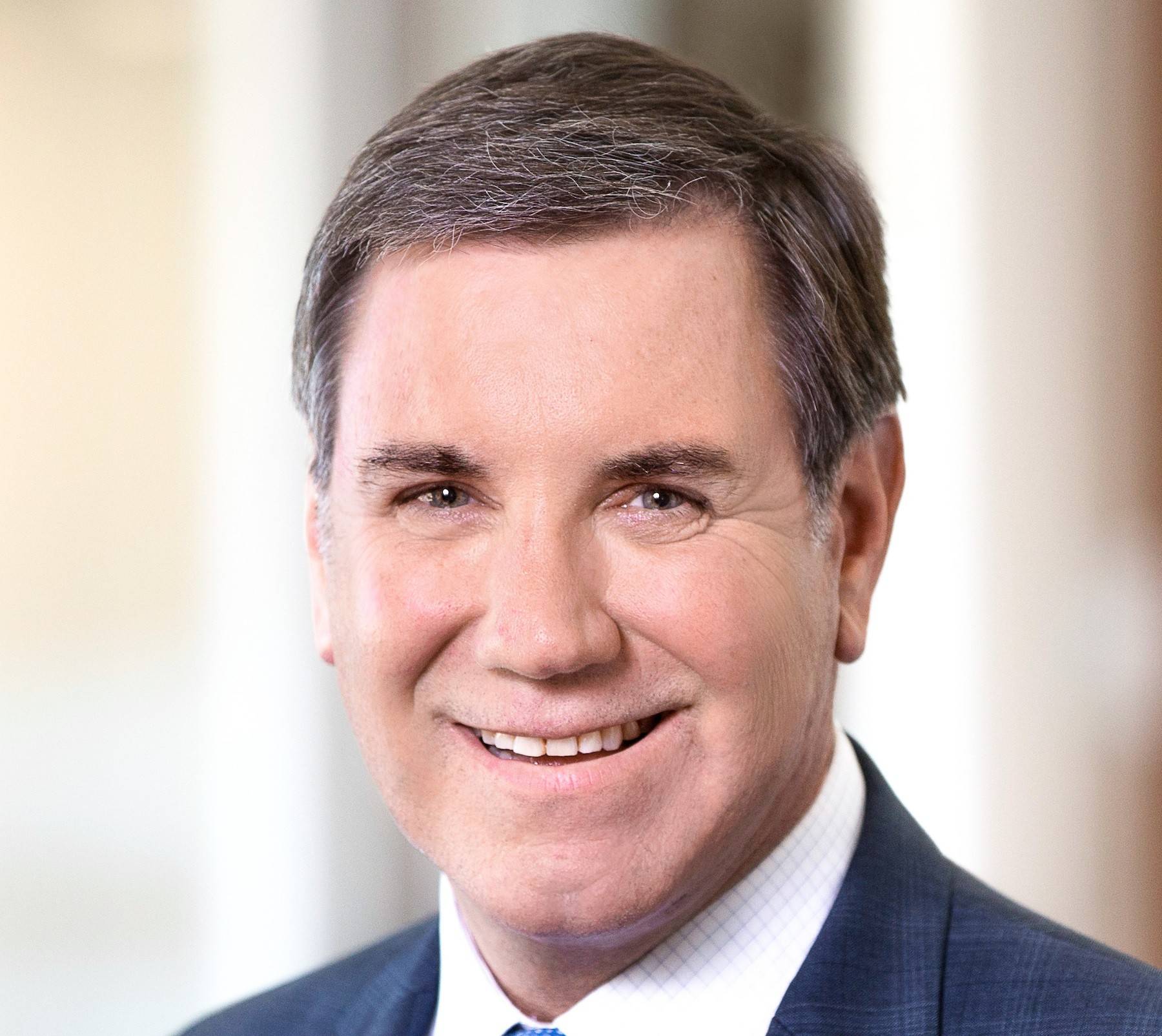 a person in a suit smiling