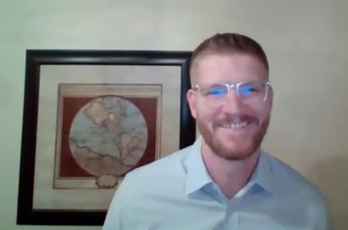 a person wearing glasses and smiling