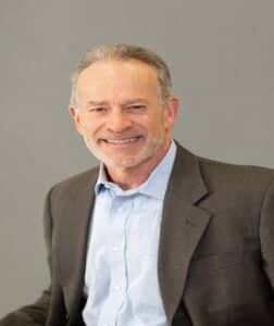 a person in a suit smiling