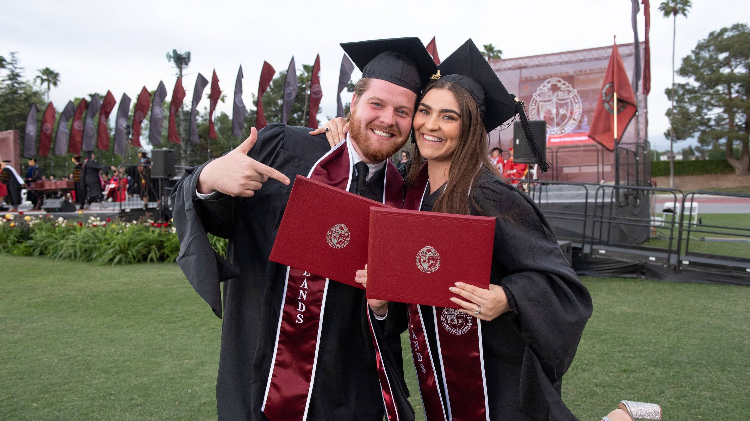 a person and person in graduation gowns and caps