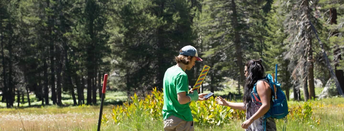 a person holding a candy and a person standing in a field