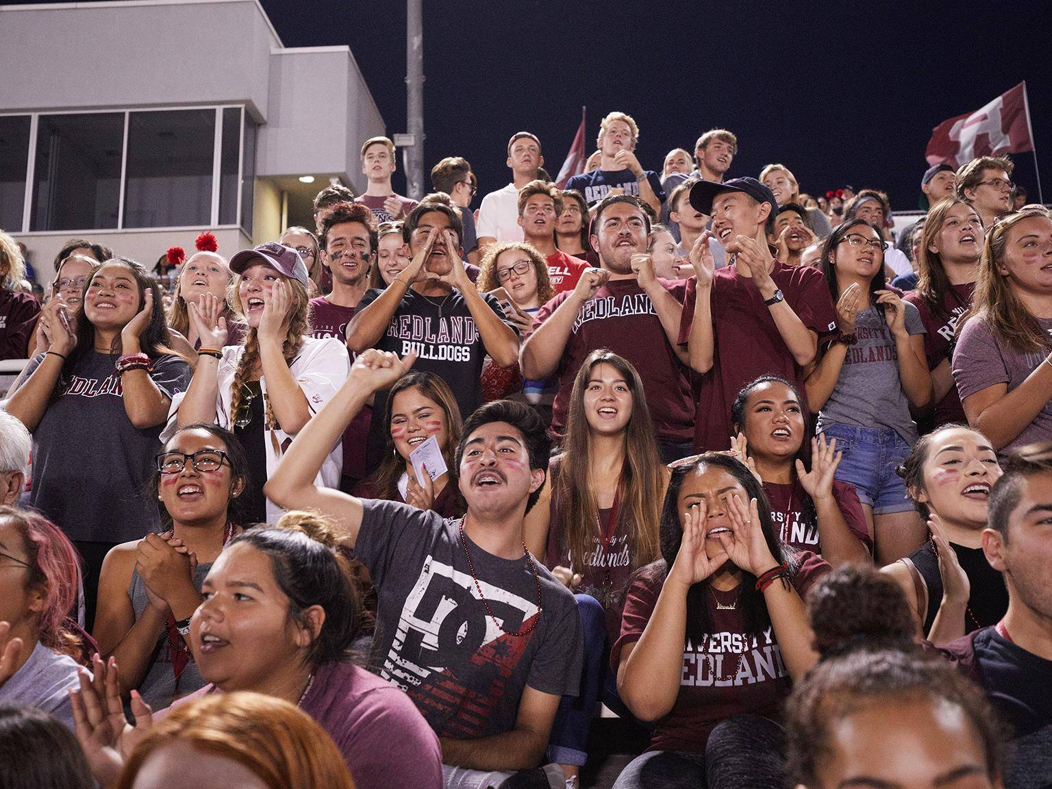 a group of people sitting in bleachers