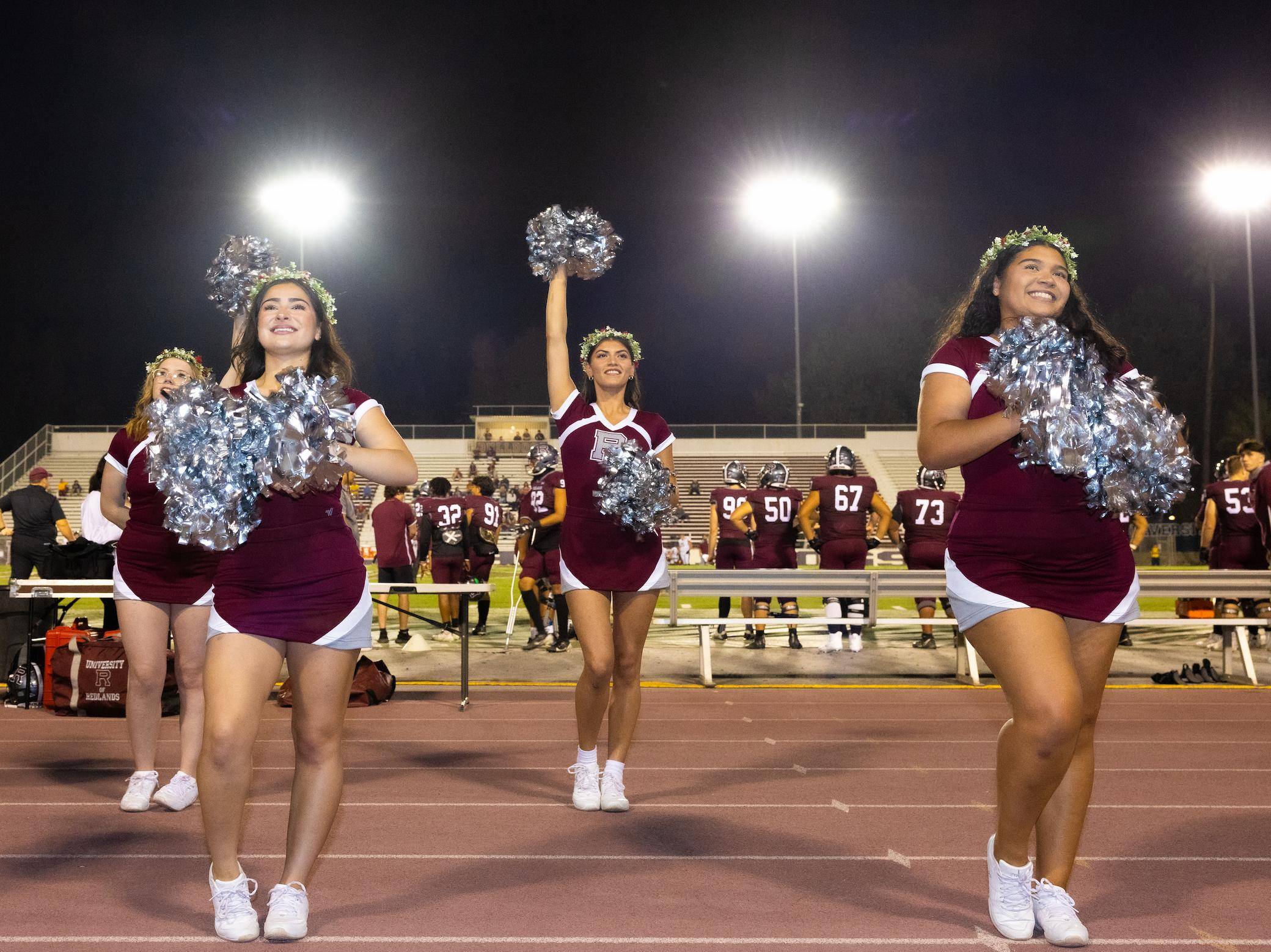 a group of cheerleaders on a football field