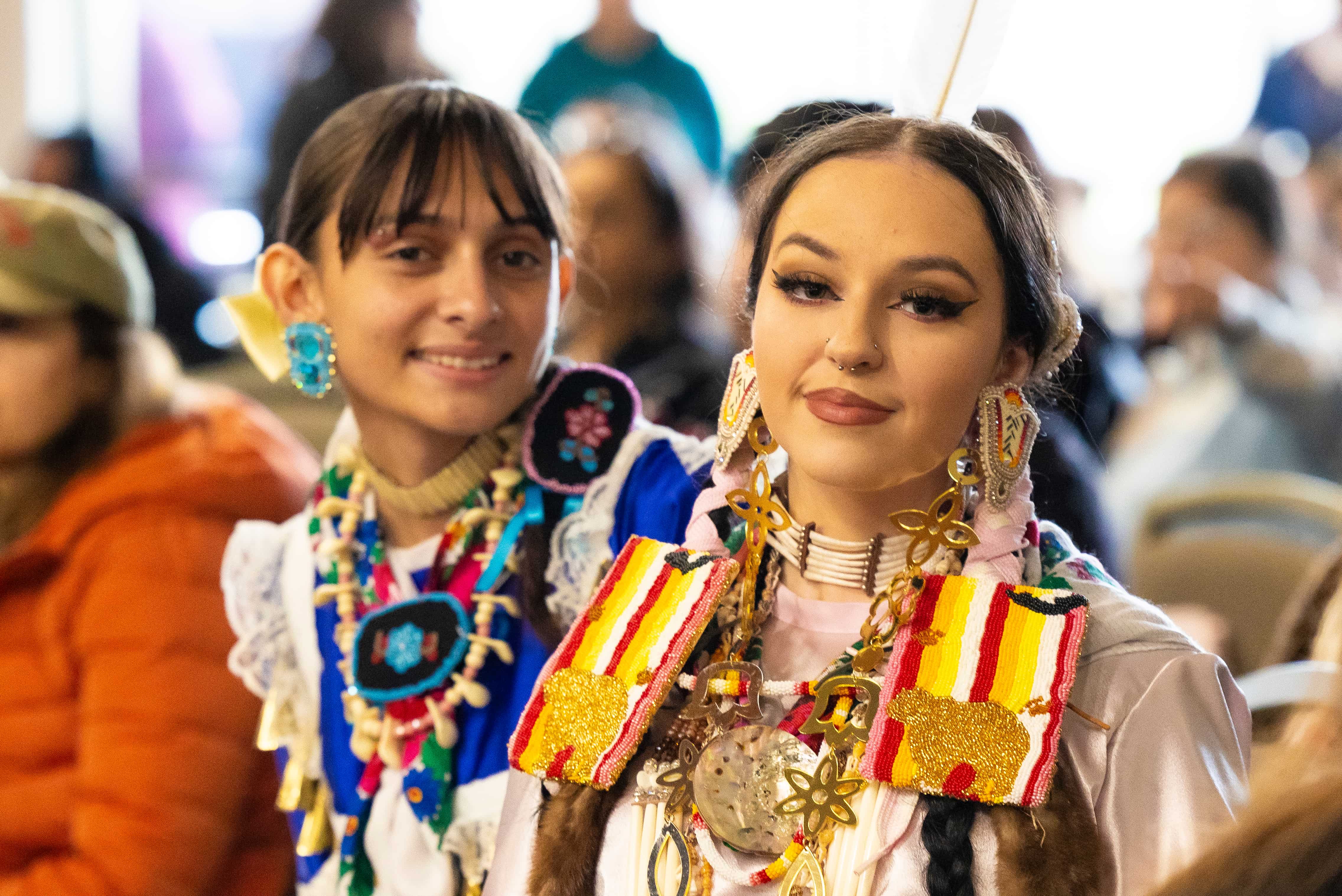 two women wearing colorful jewelry