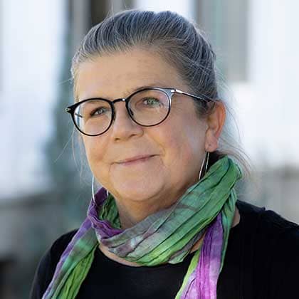 a person wearing glasses and a scarf