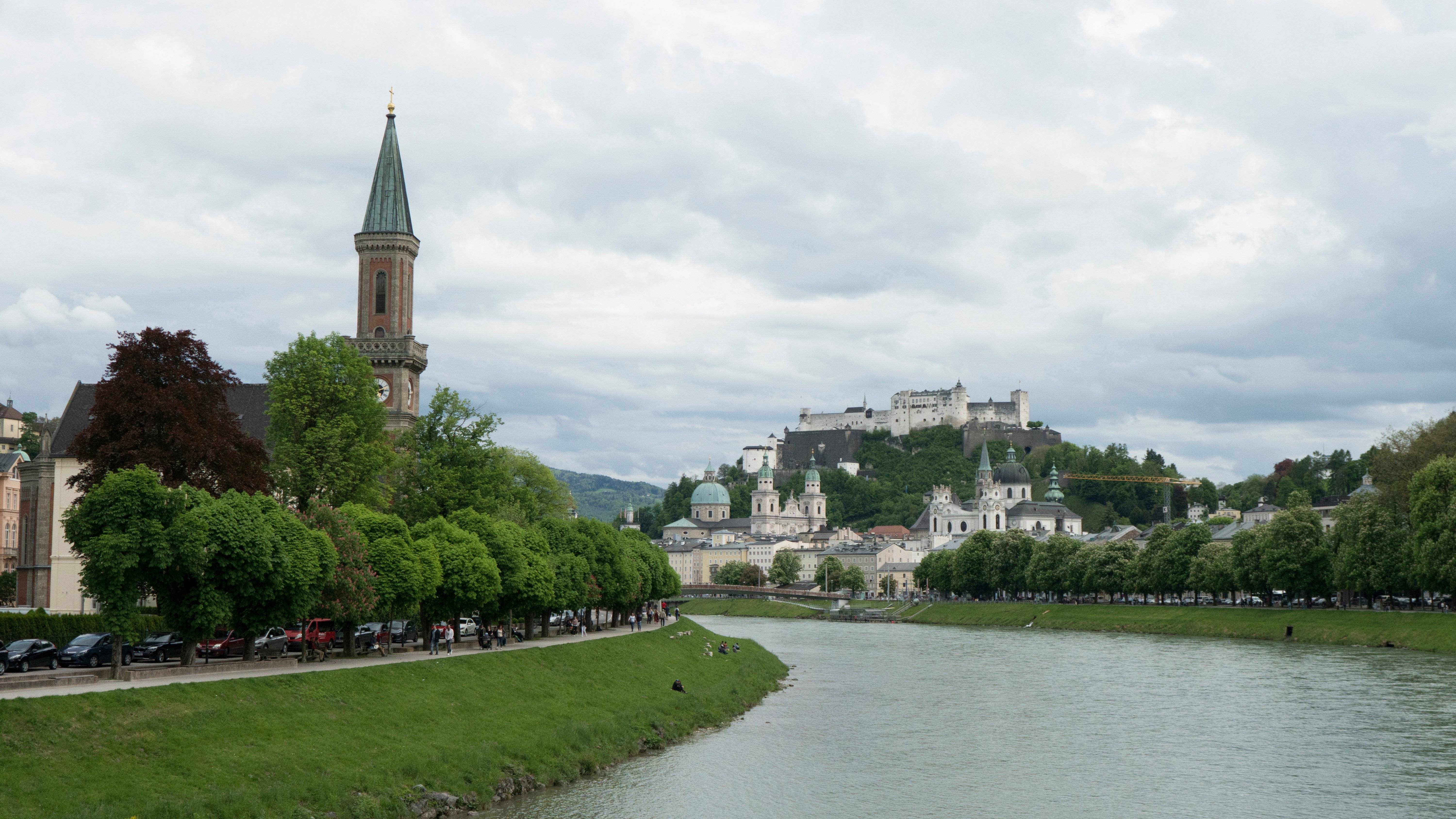 a river with trees and a castle on top