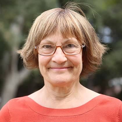 a person wearing glasses and smiling