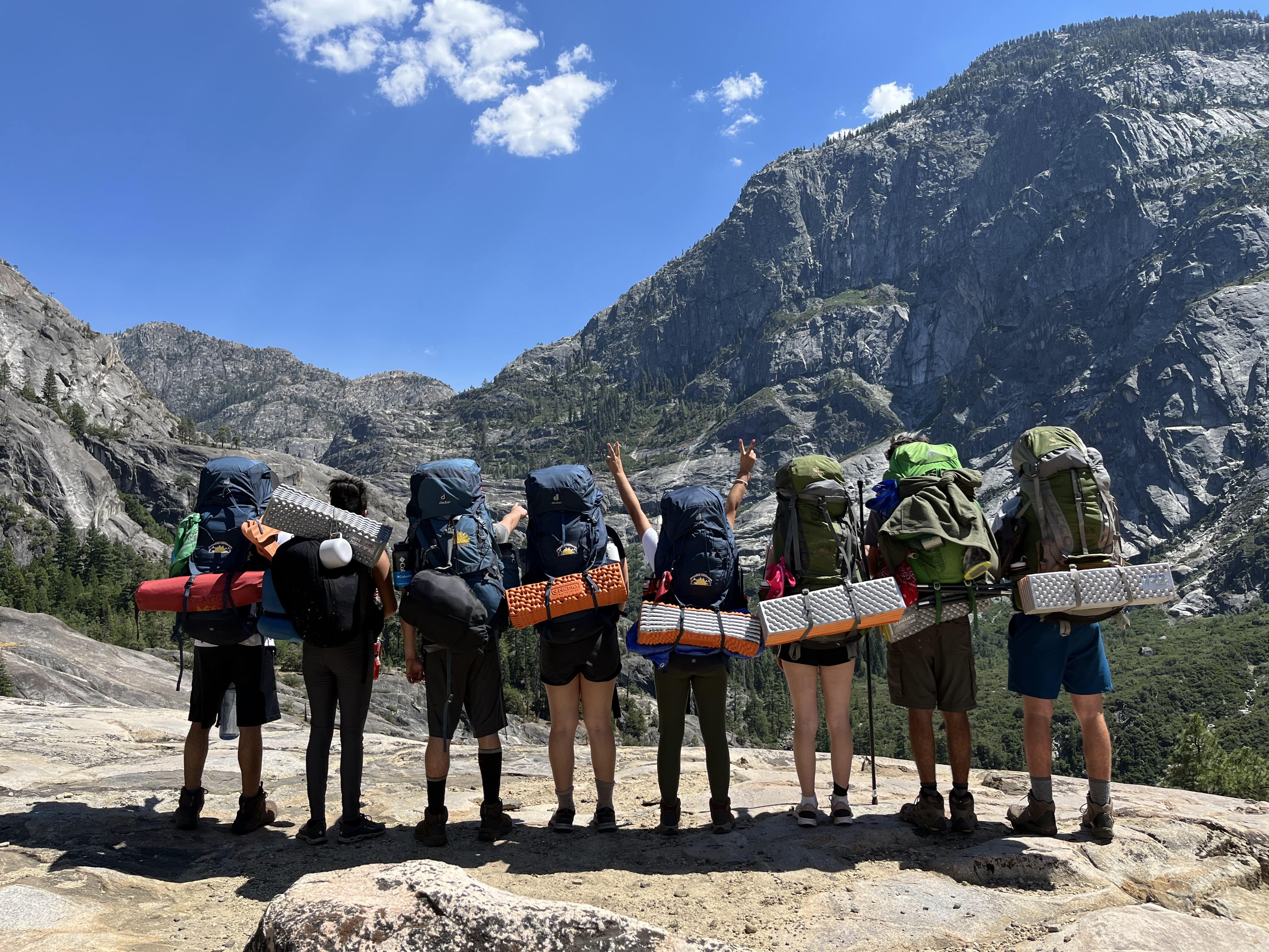 a group of people with backpacks on their backs