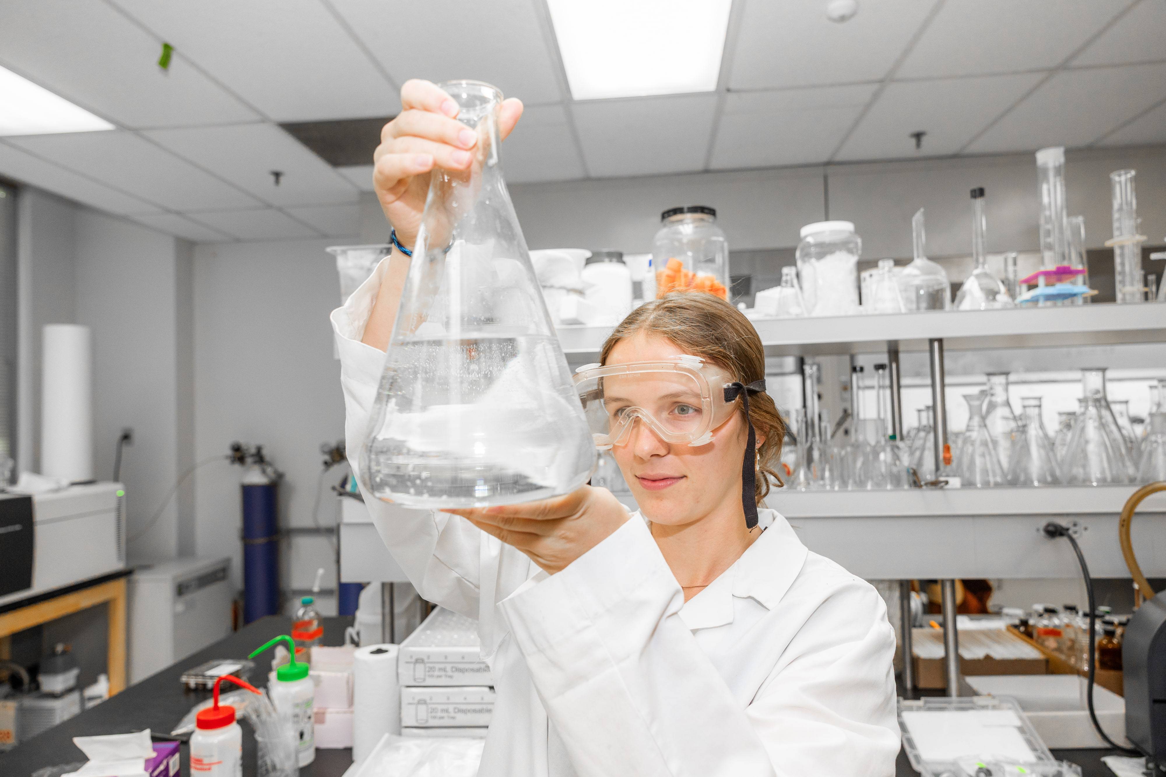 a person holding a beaker