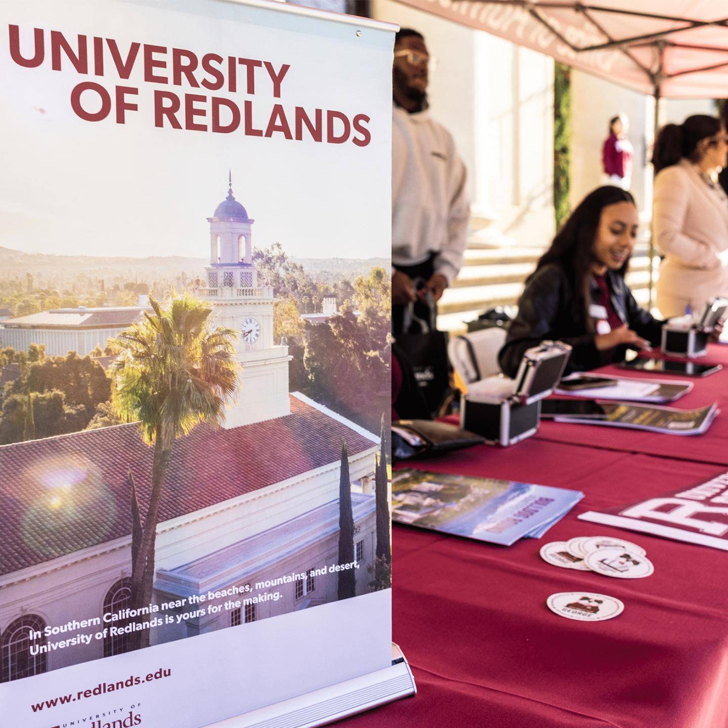 a table with red tablecloths and a sign