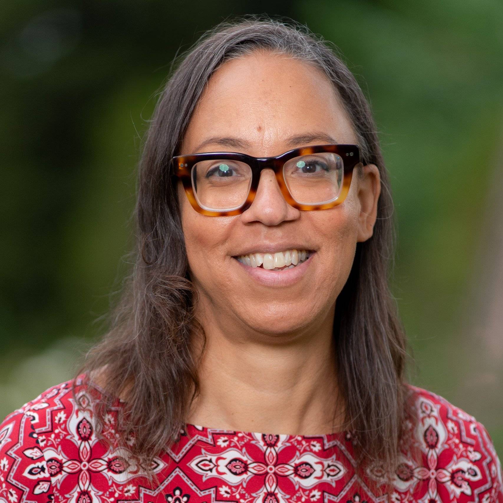 a person wearing glasses smiling