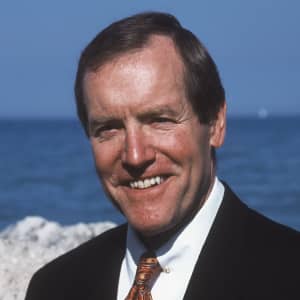 a person in a suit smiling