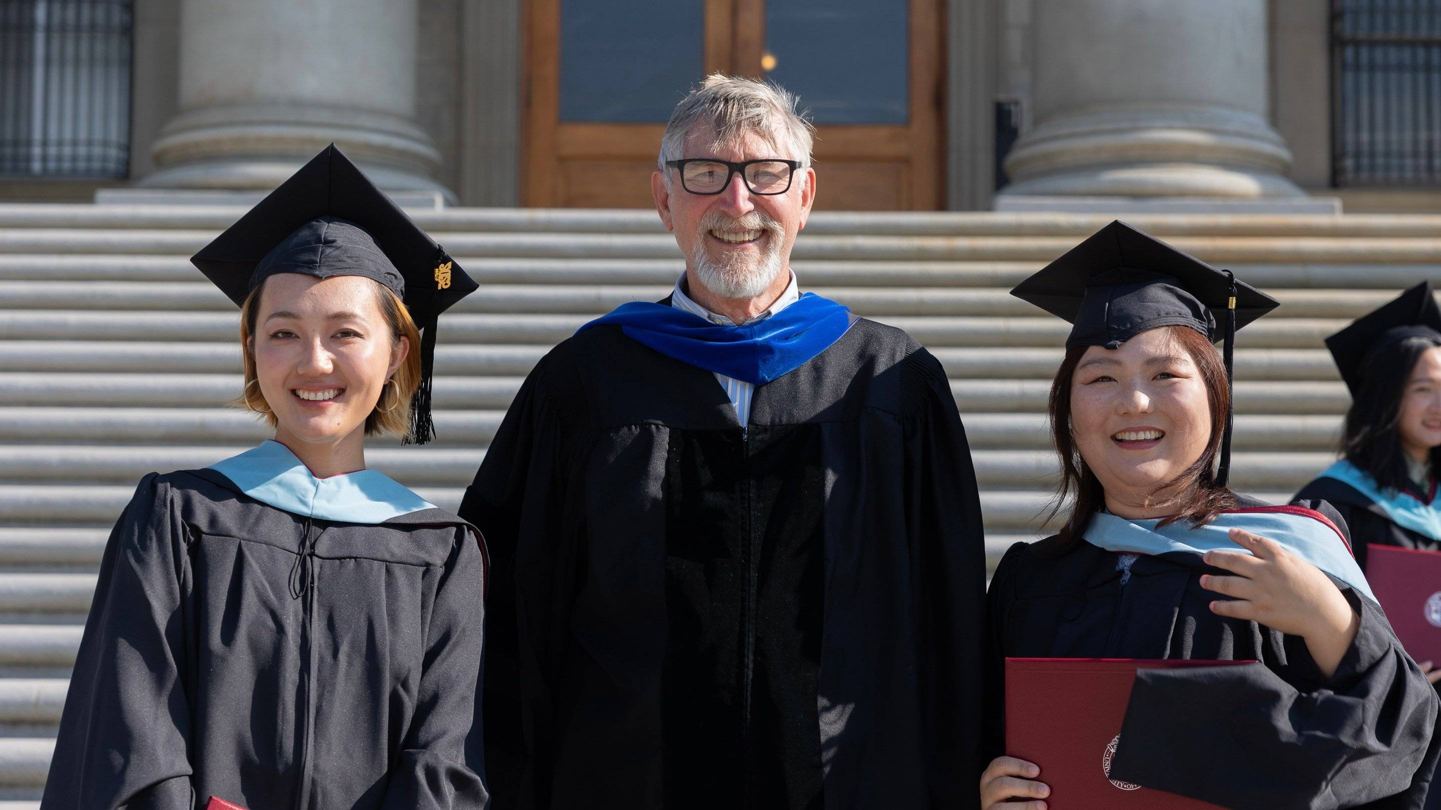 a group of people in graduation gowns and caps