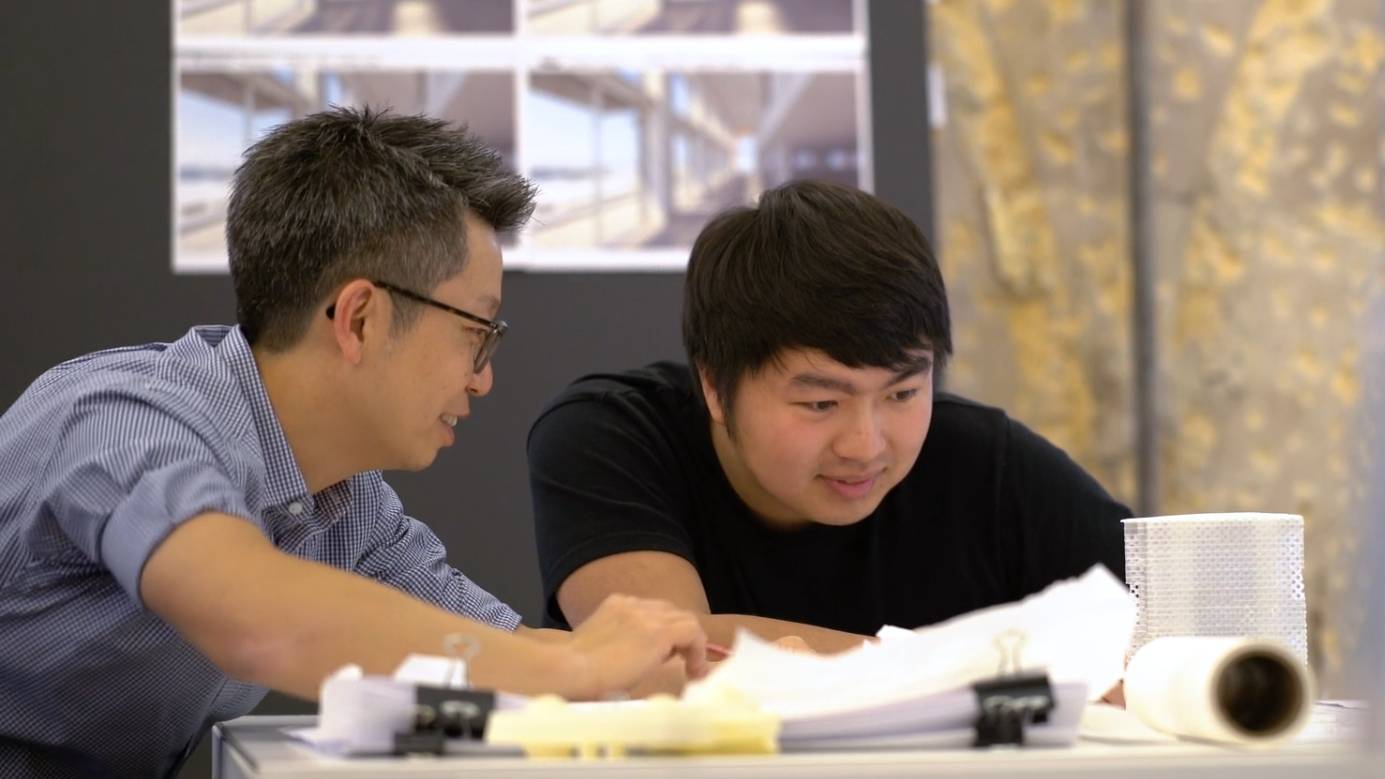 a couple of men looking at papers