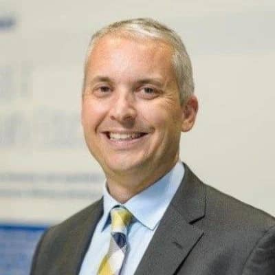 a person in a suit smiling