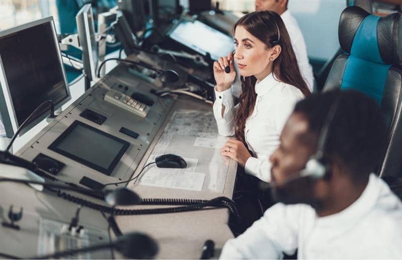 a person sitting at a desk with a headset