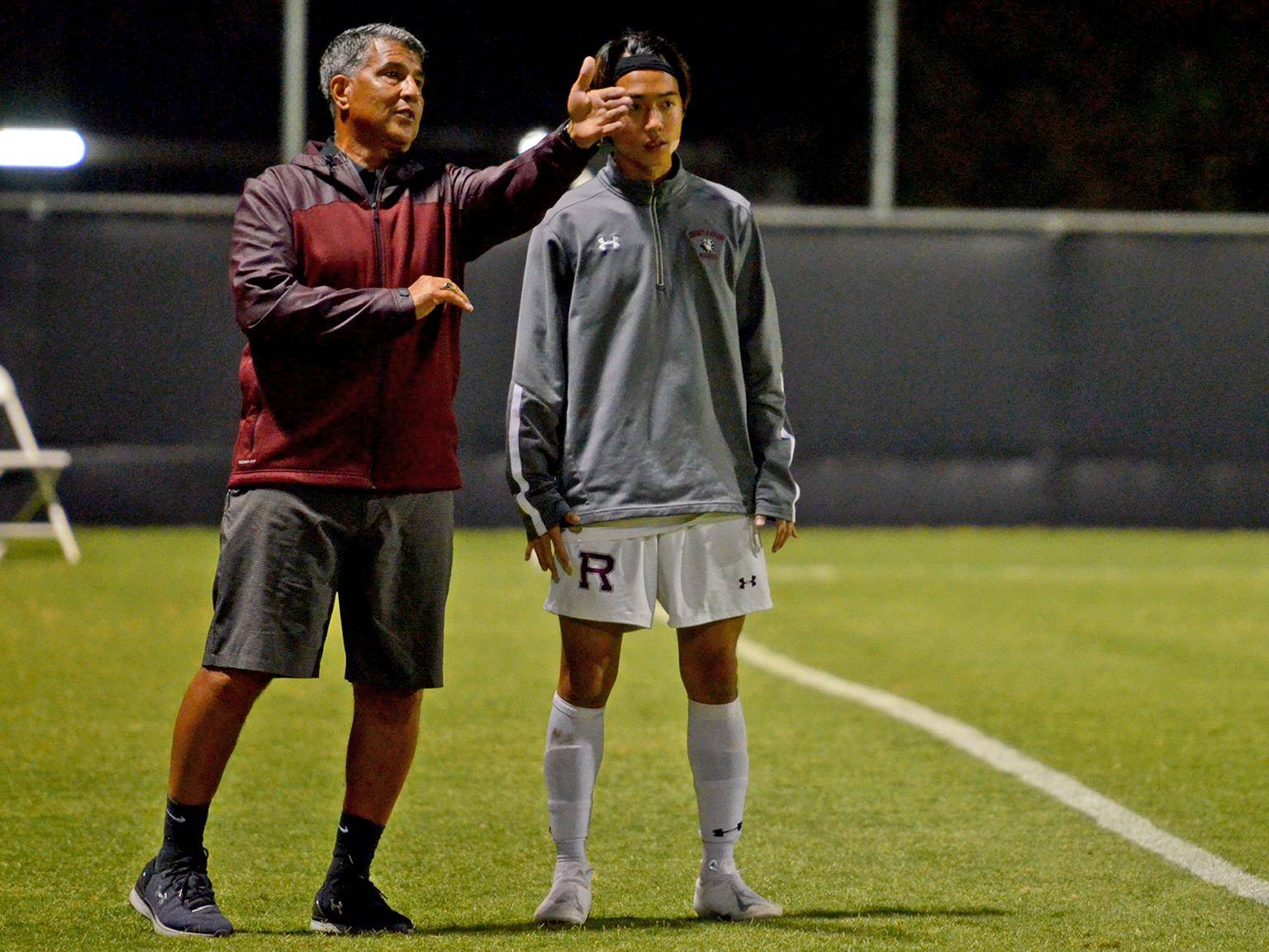 a person giving a high five to a person on a football field