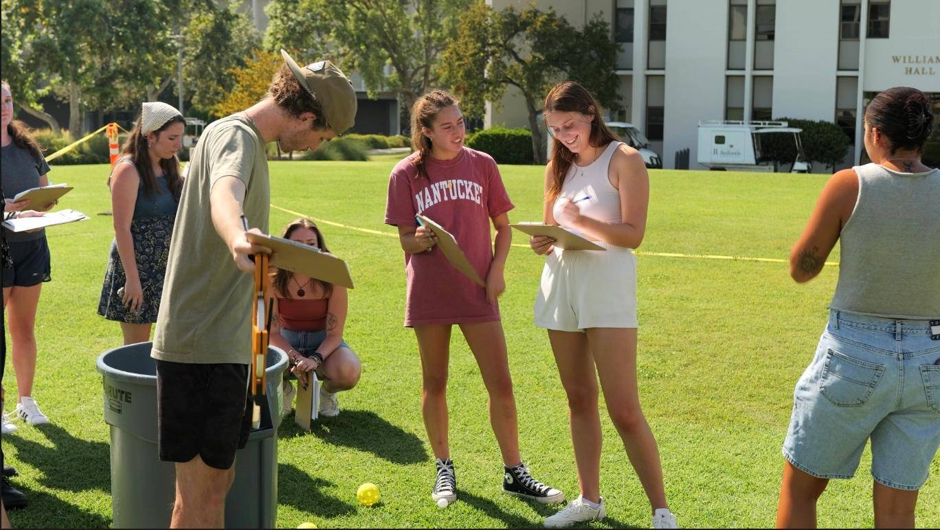 a group of people on a grass field