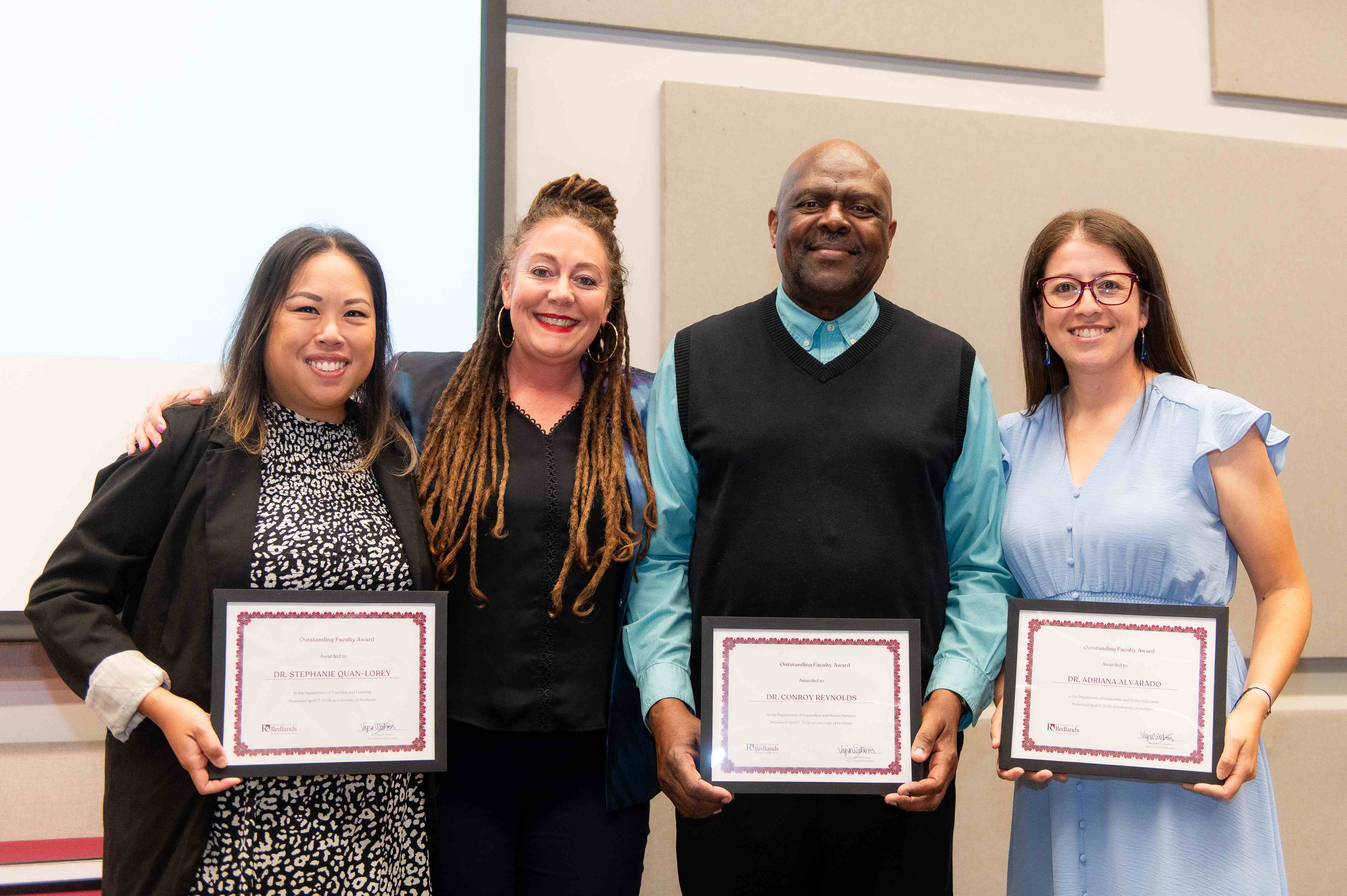a group of people holding certificates