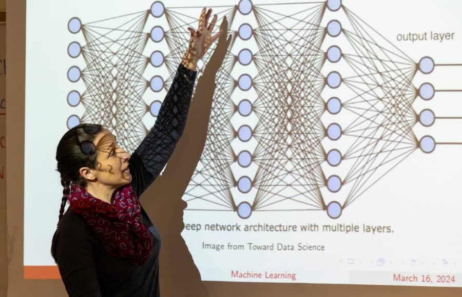 a person standing in front of a projection screen