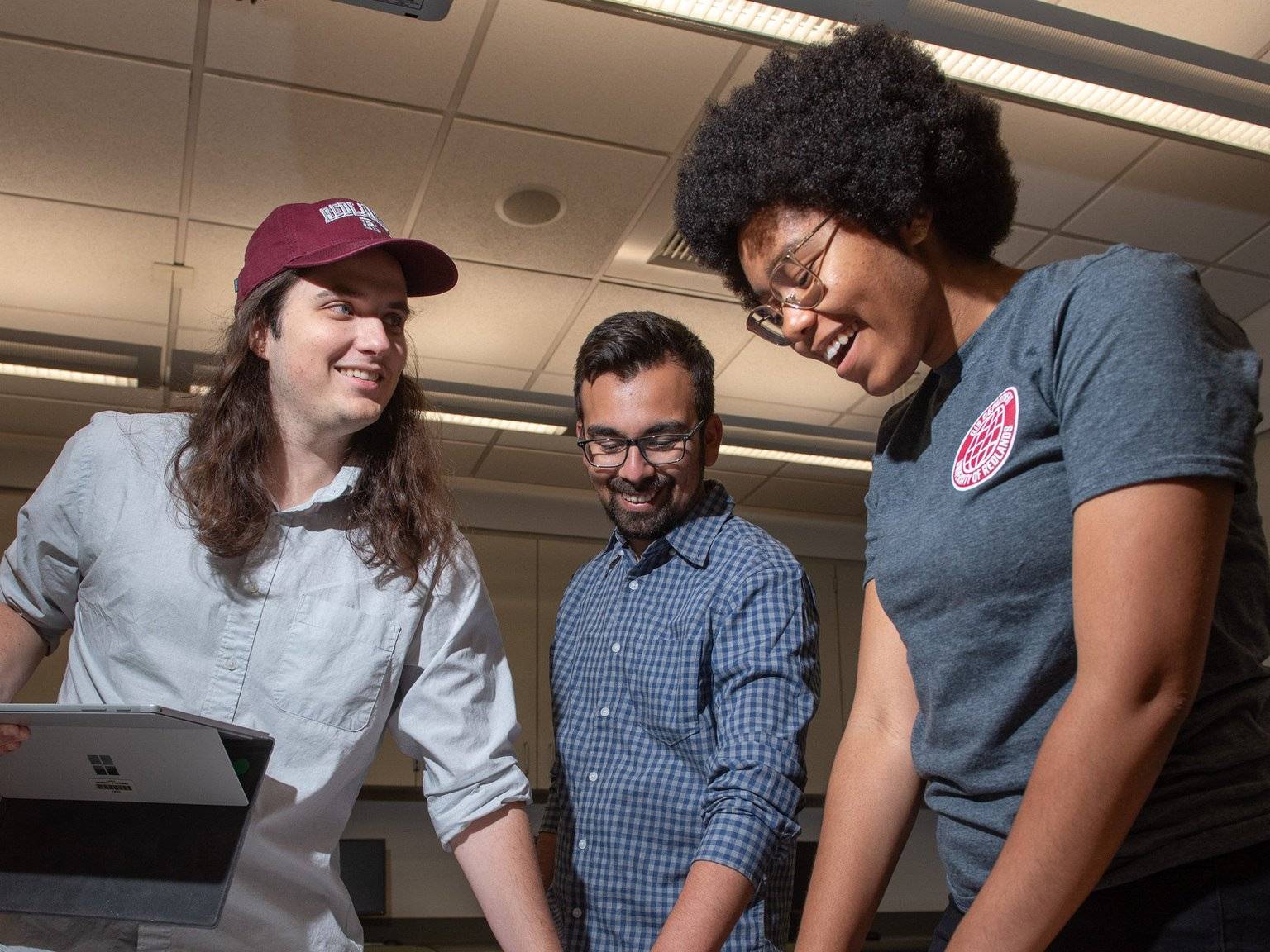 a group of people standing around a table