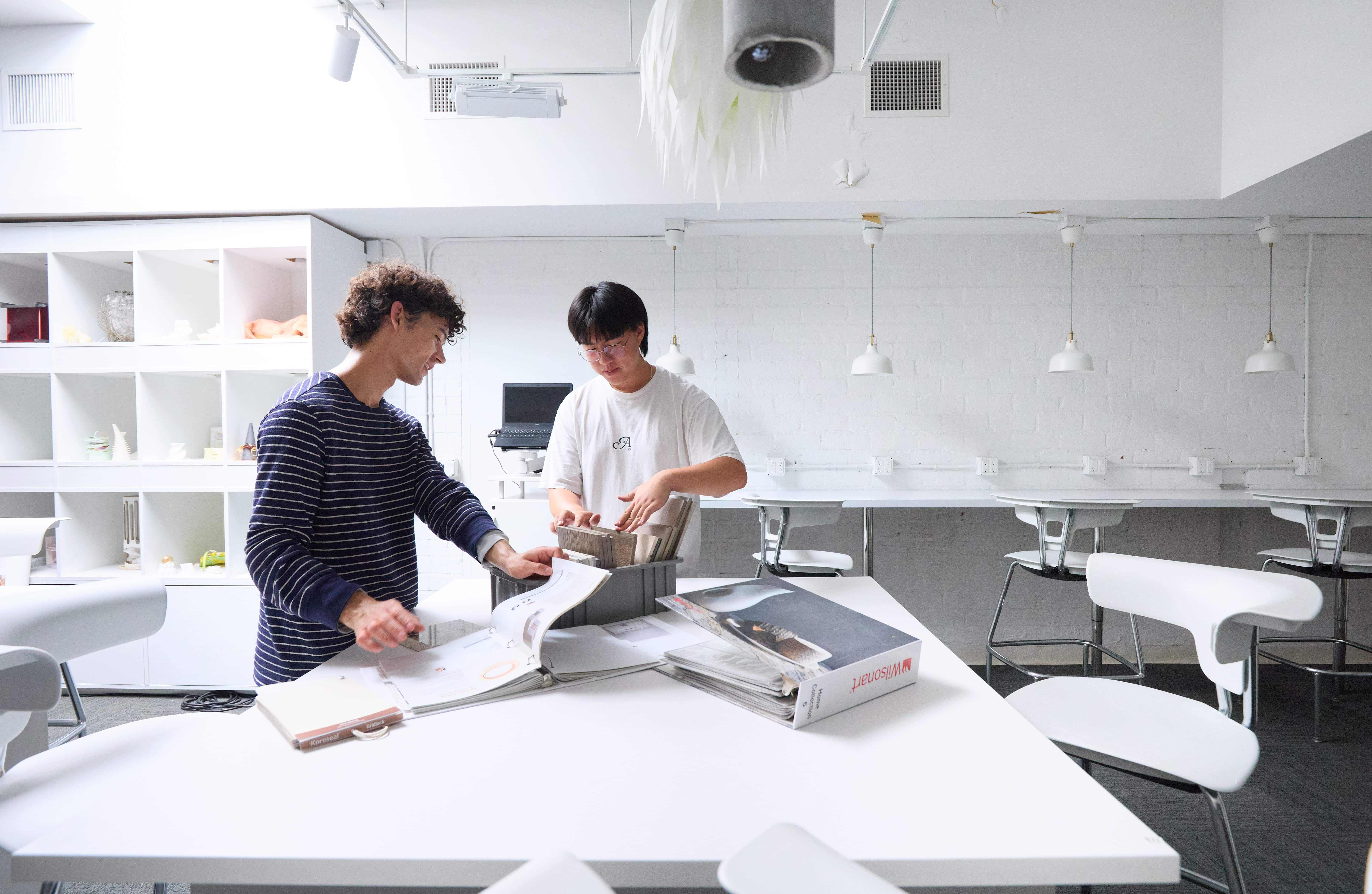 two men standing around a table