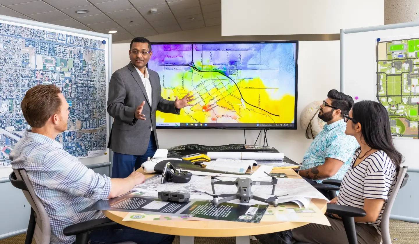 a person standing in front of a large screen