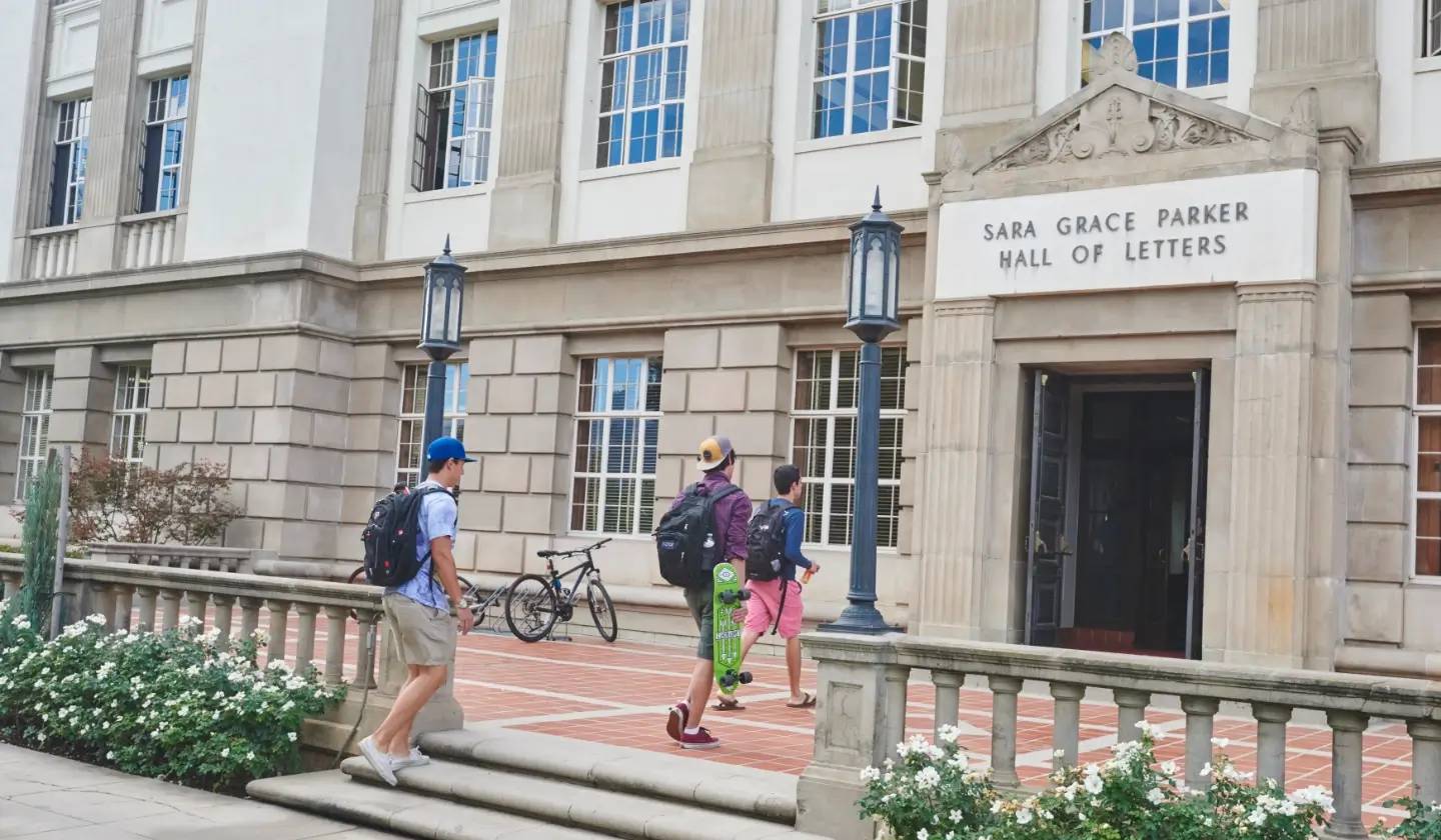 a group of people walking down stairs in front of a building