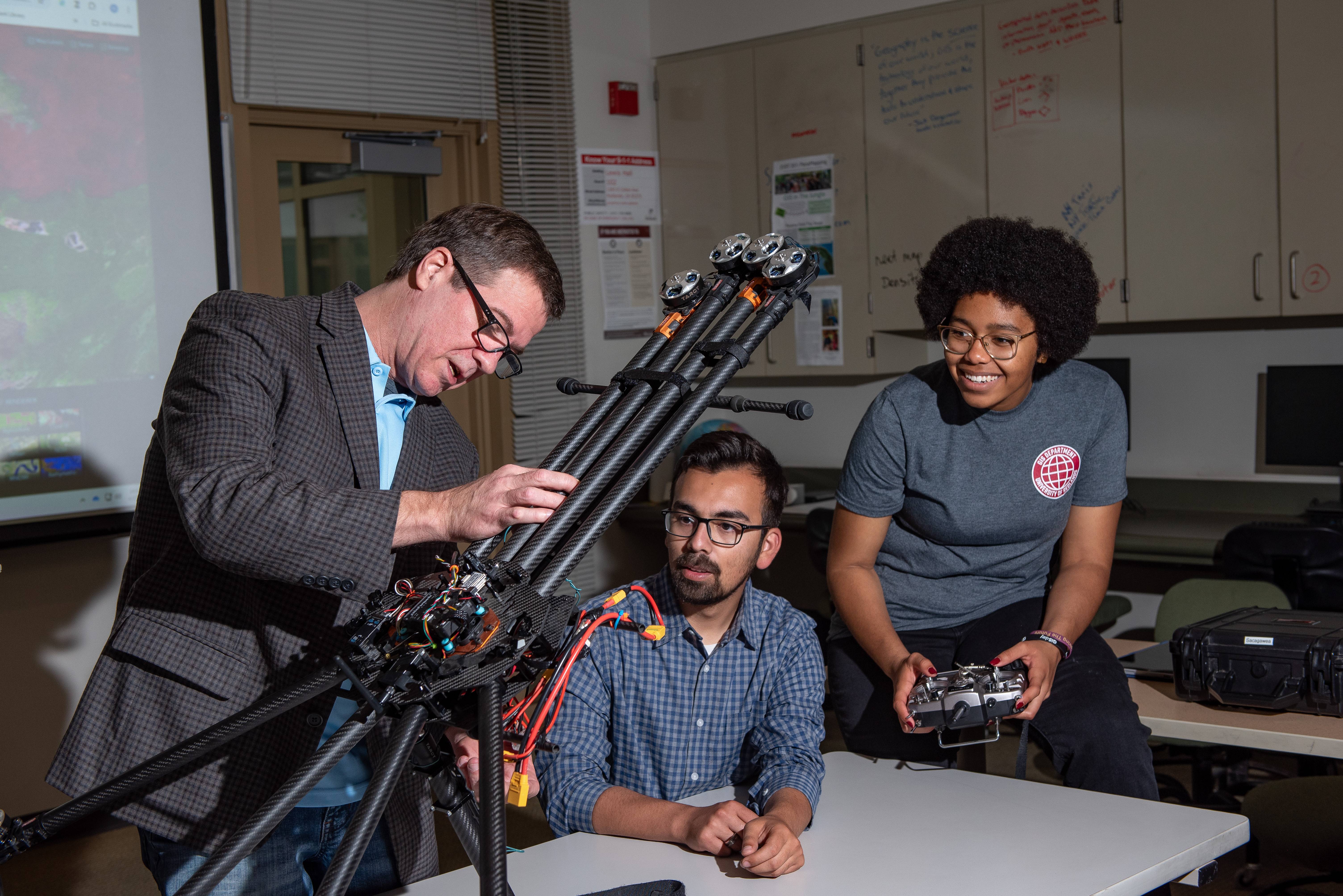 a person standing next to a person holding a machine