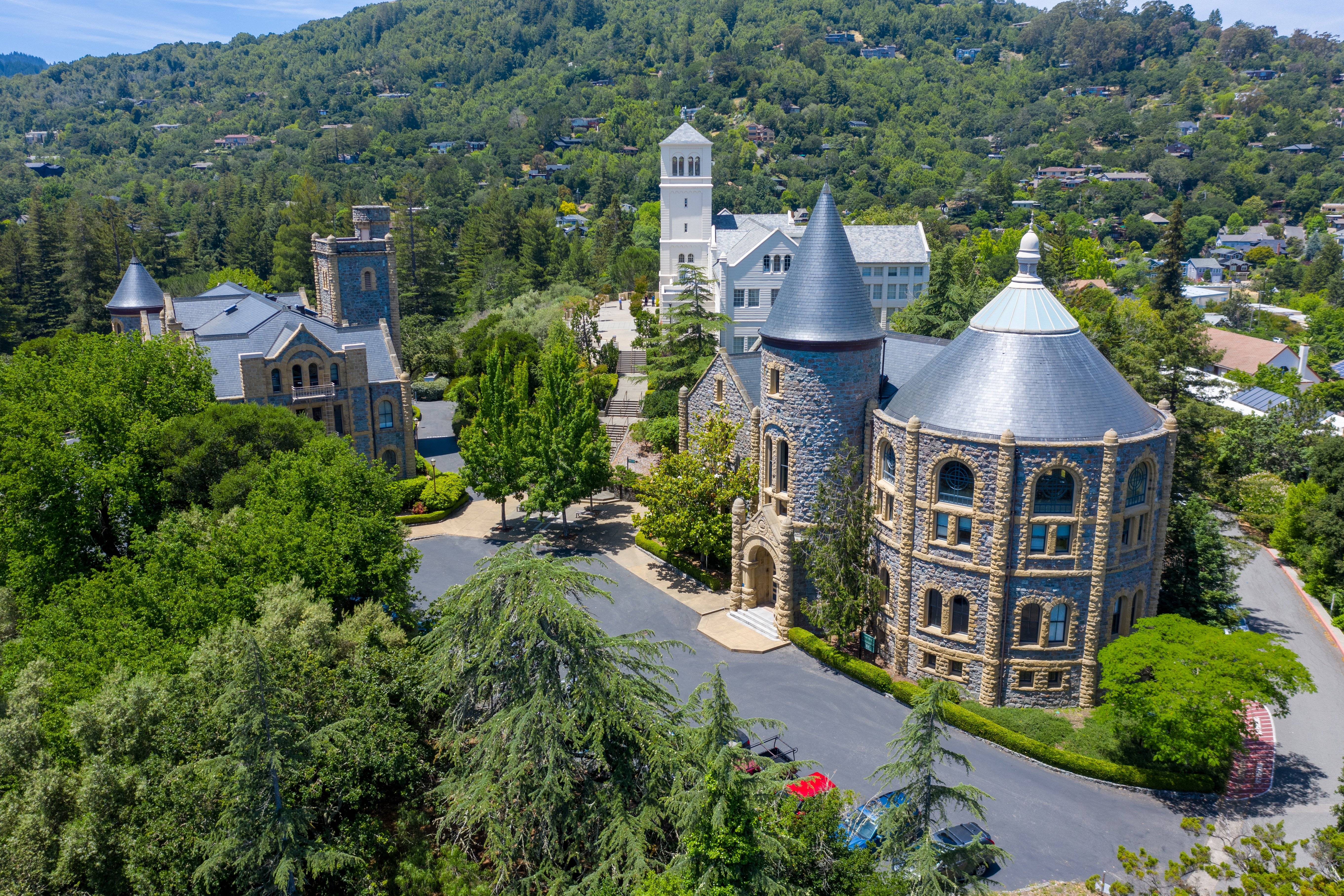 a large stone castle surrounded by trees