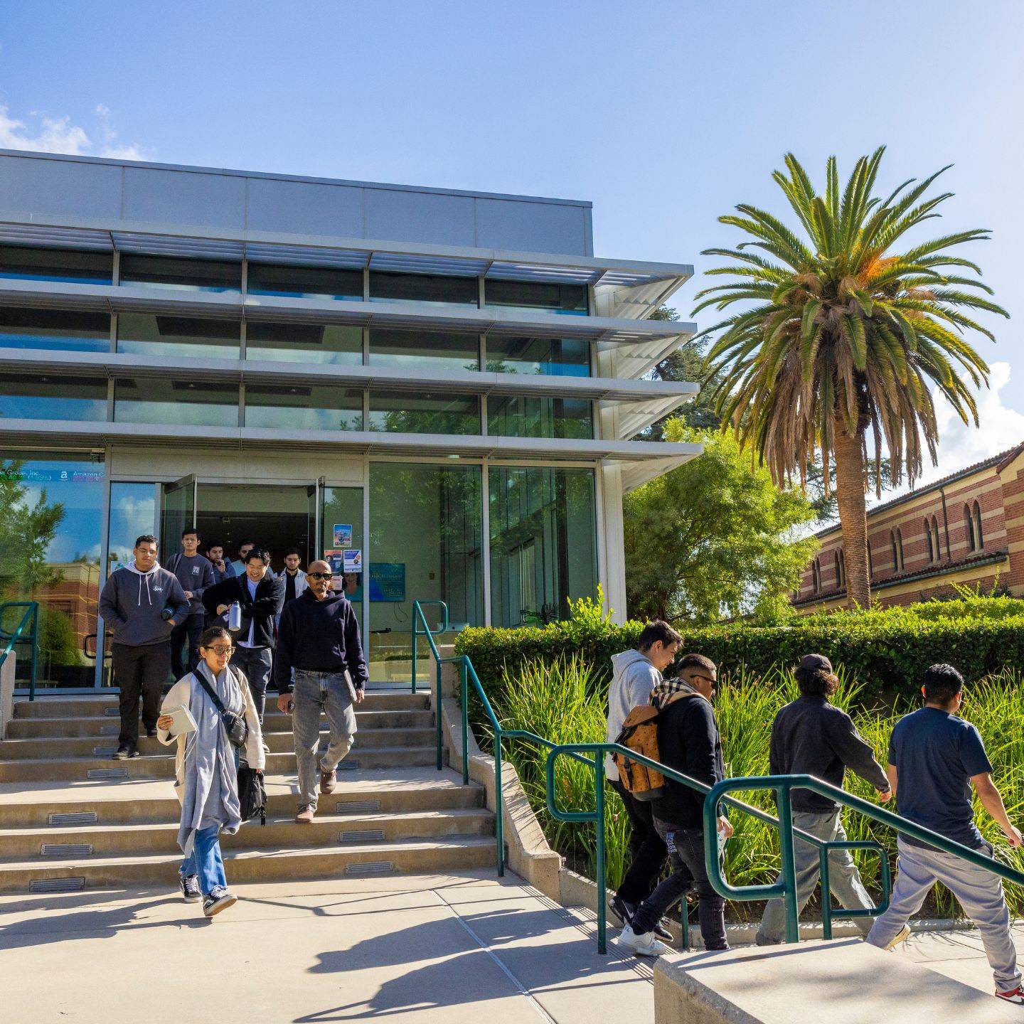 a group of people walking up stairs outside a building