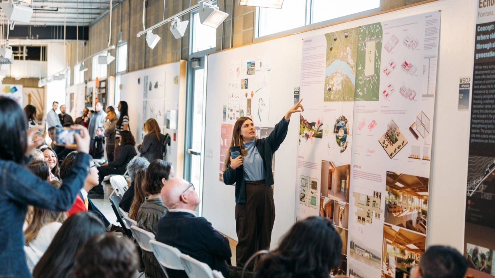 a person pointing at a poster