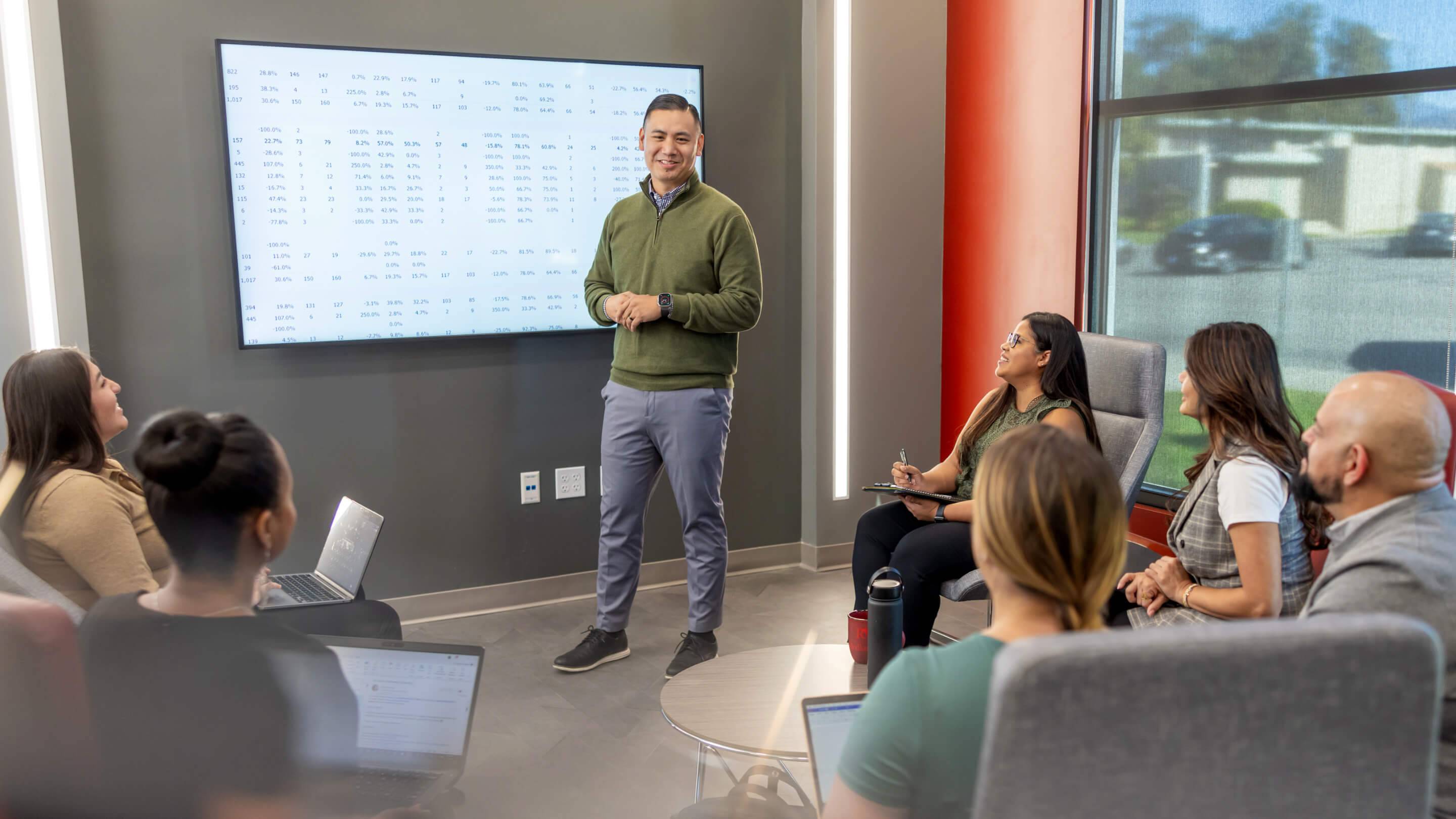 a person standing in front of a screen