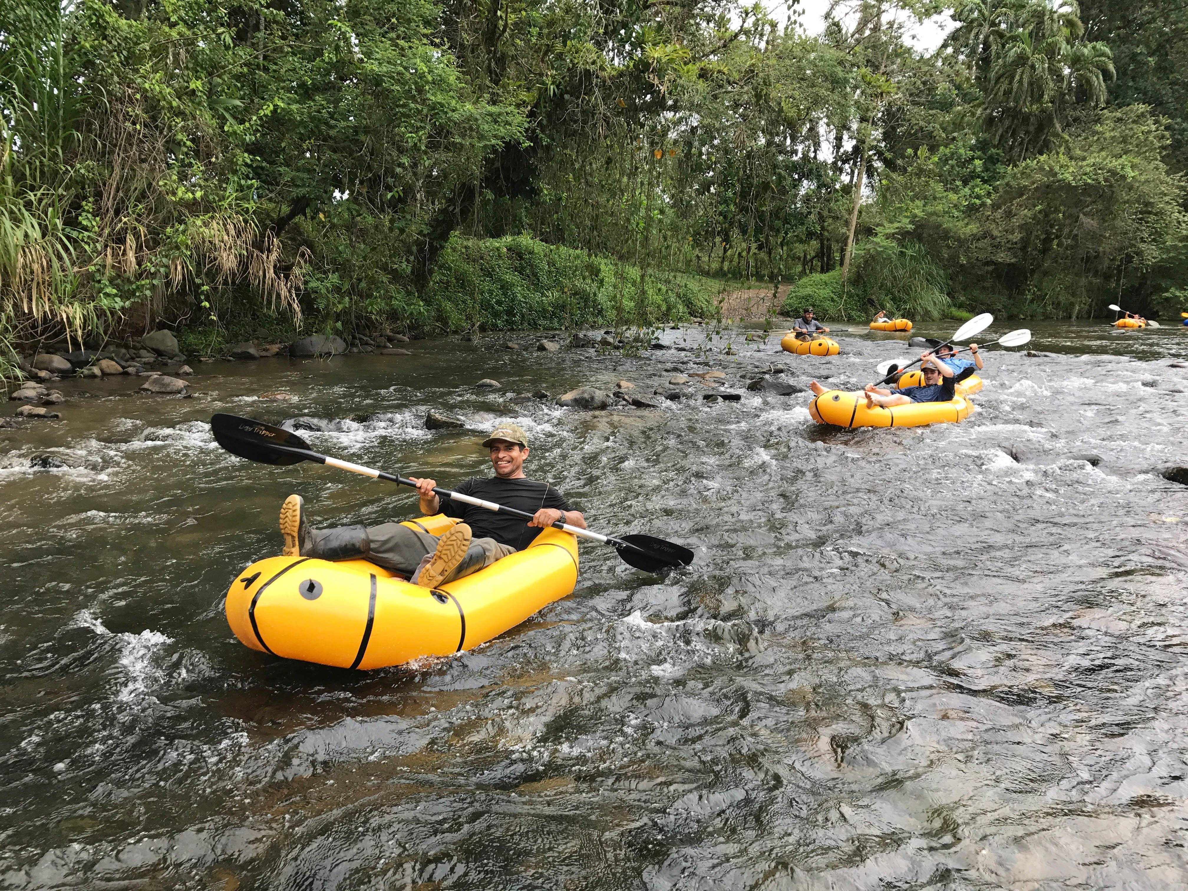 a group of people in rafts on a river