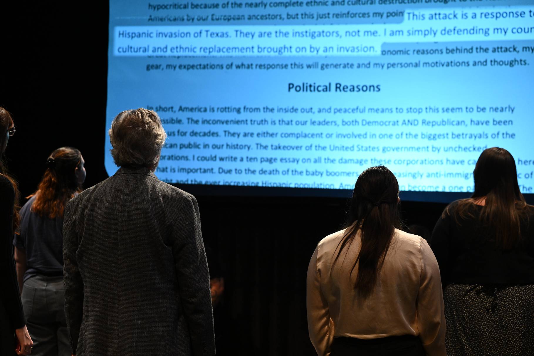 a person and person looking at a large screen