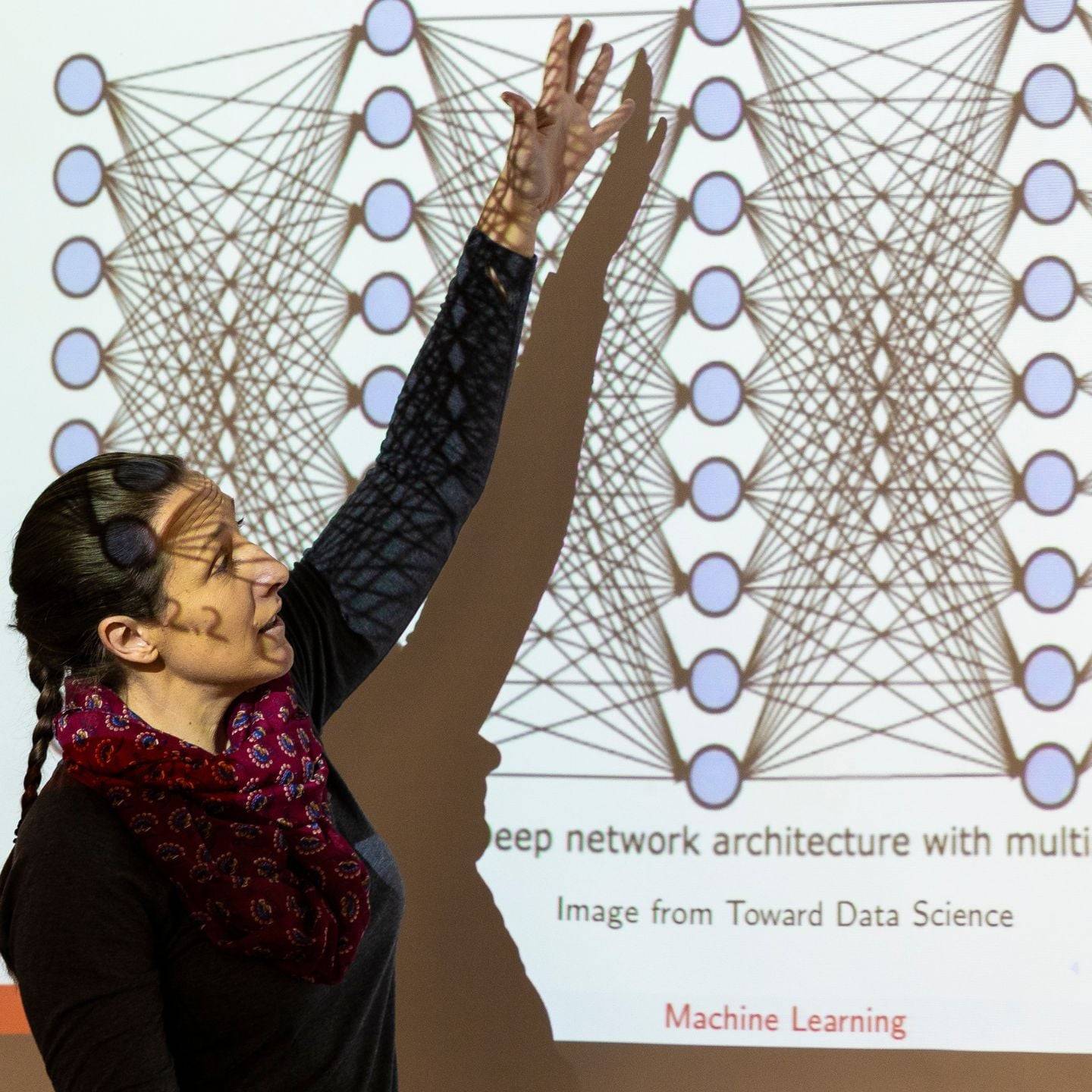 a person standing in front of a screen