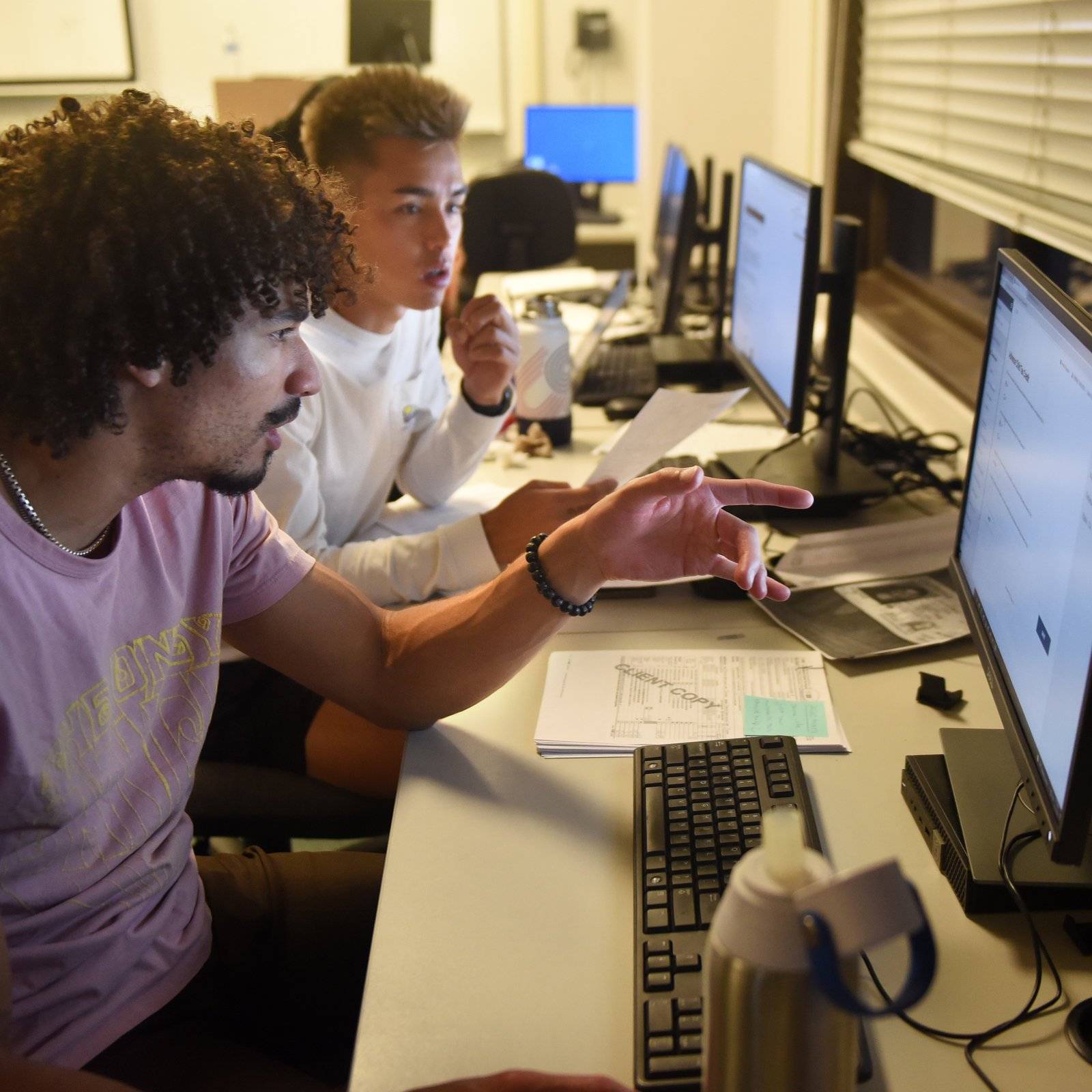 a group of men looking at a computer screen