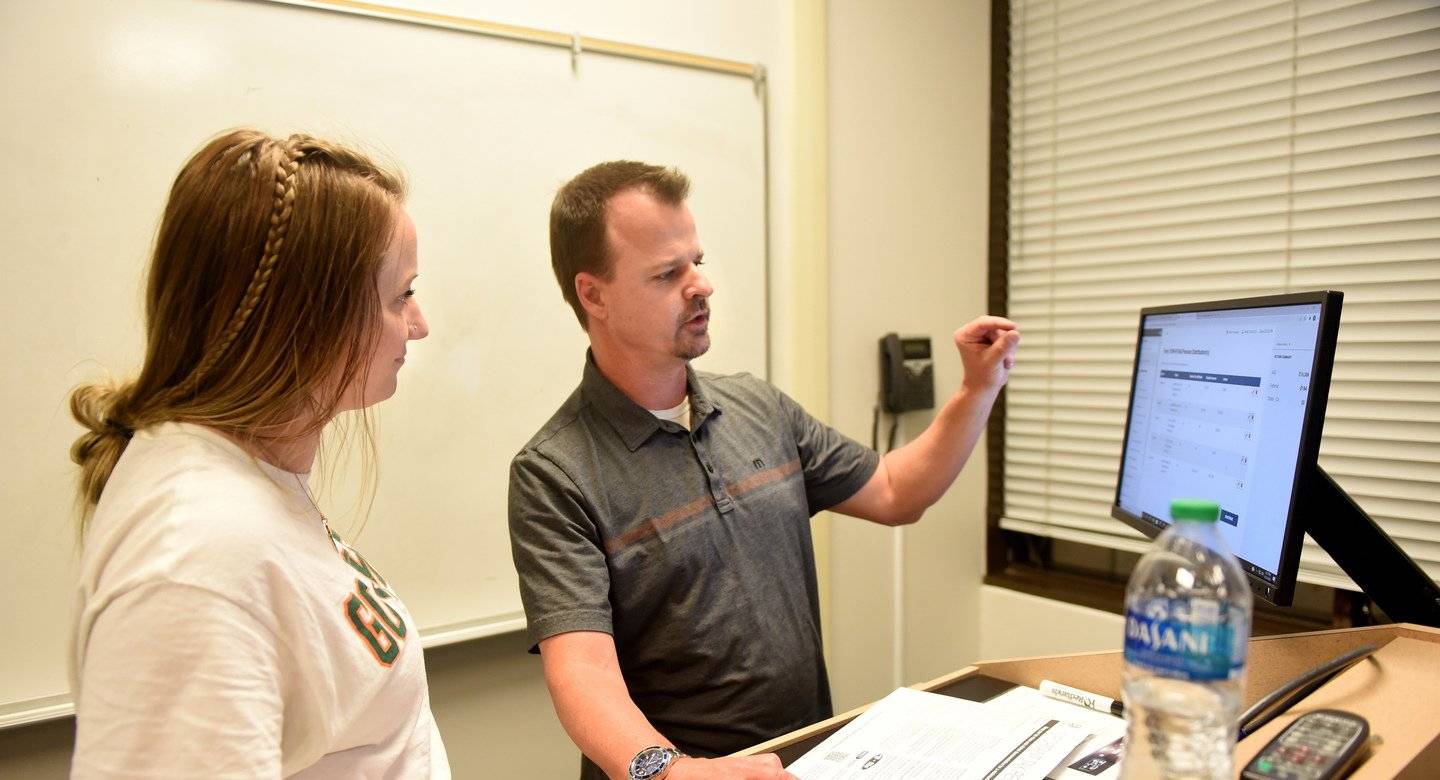 a person and person standing in front of a whiteboard