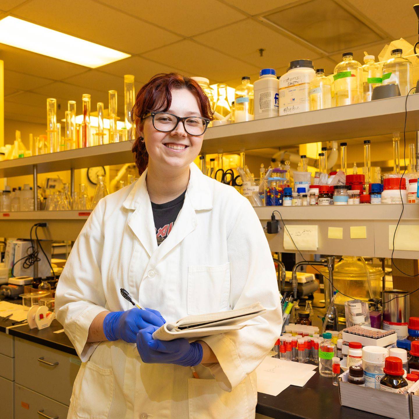 a person in a lab coat holding a notebook