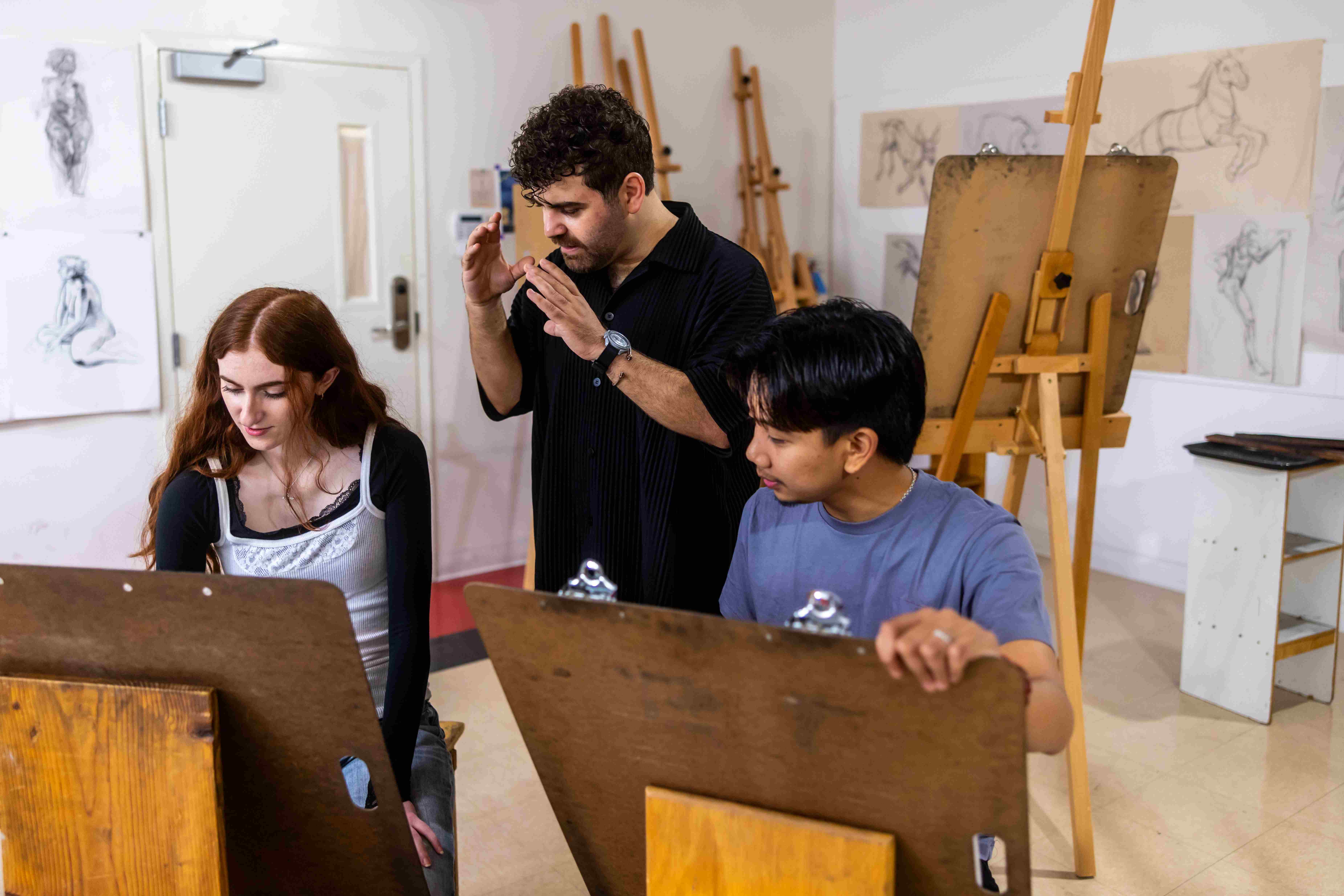 a group of people sitting in front of easels