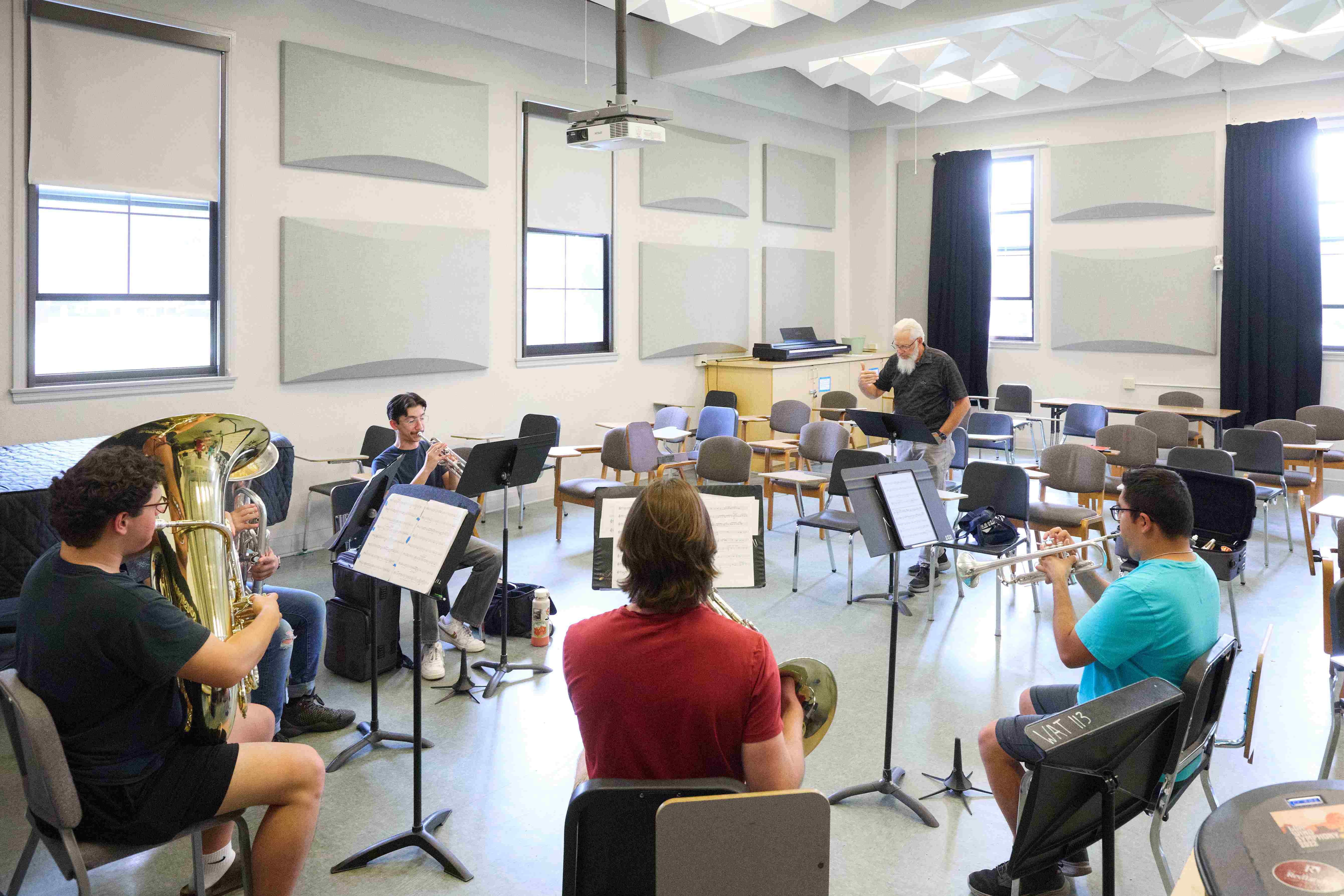 a group of people in a room with musical instruments