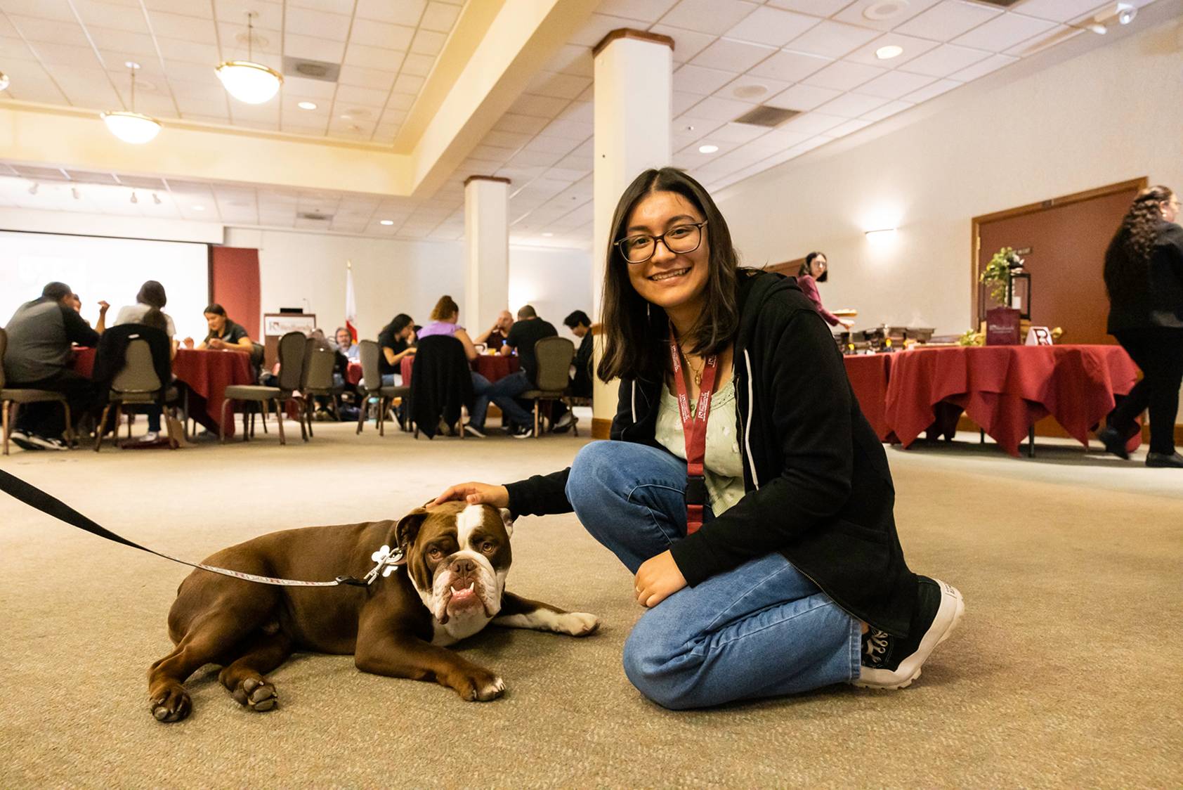 a person sitting on the floor with a dog