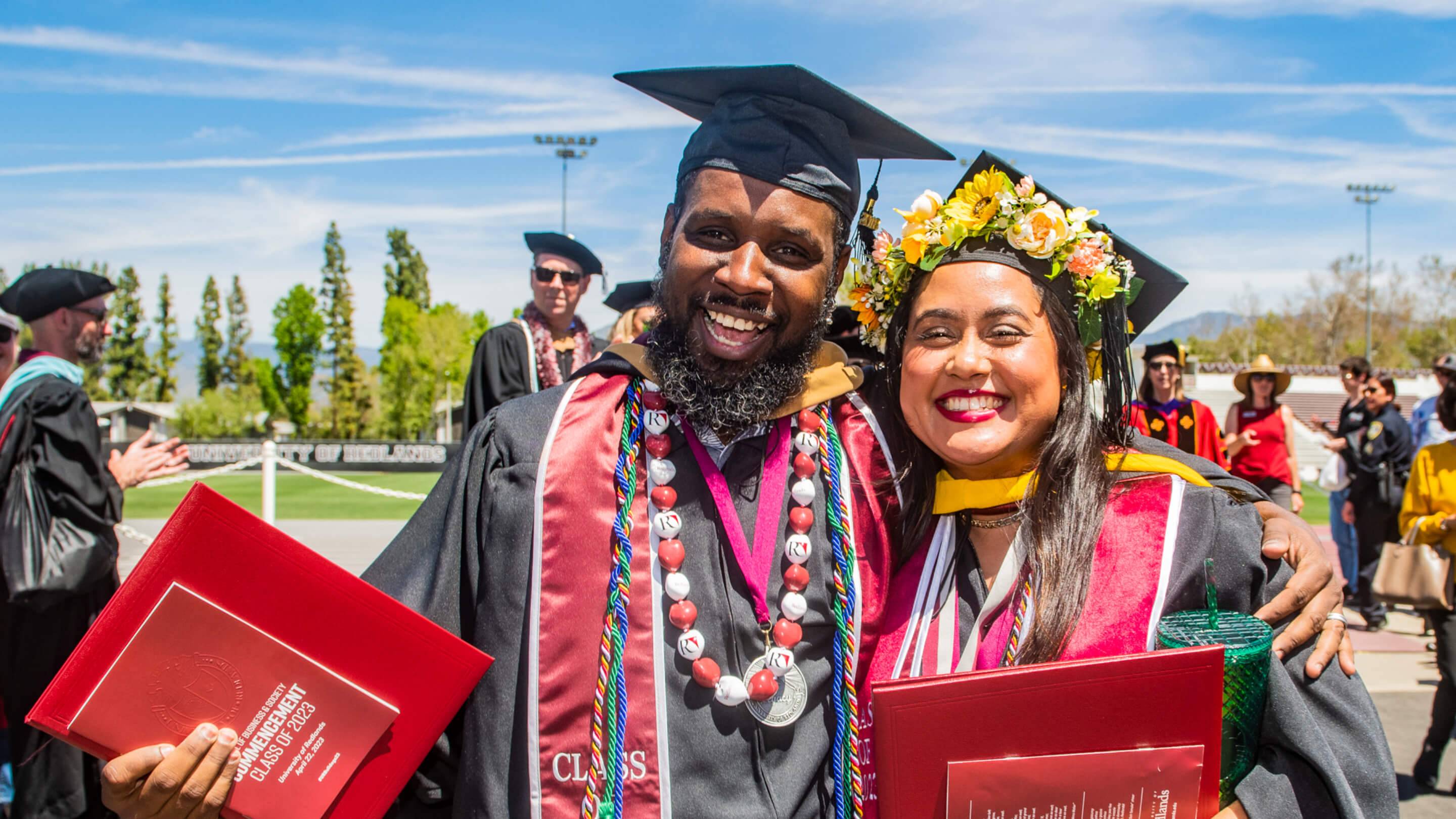 a person and person in graduation gowns and caps