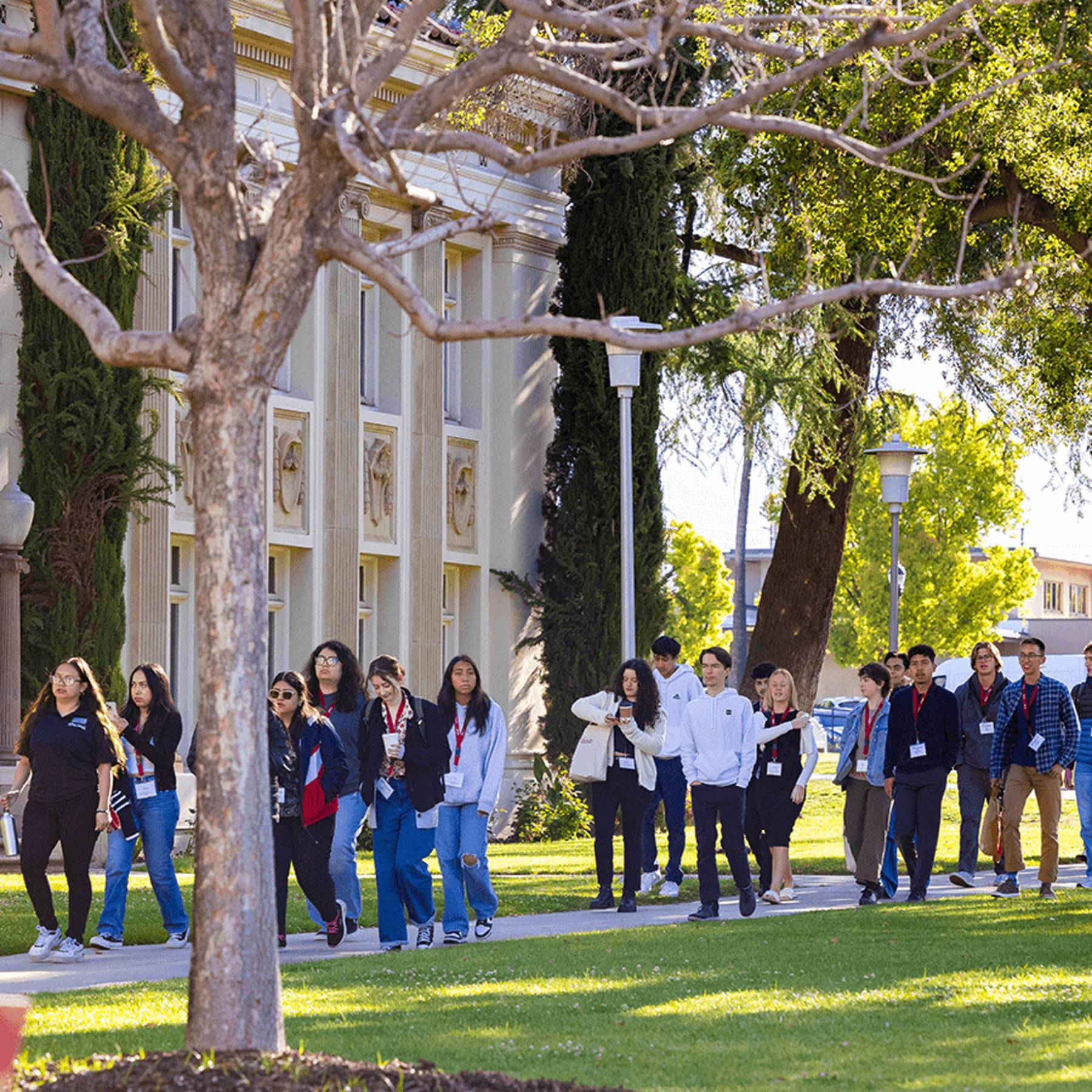 a group of people walking on a sidewalk